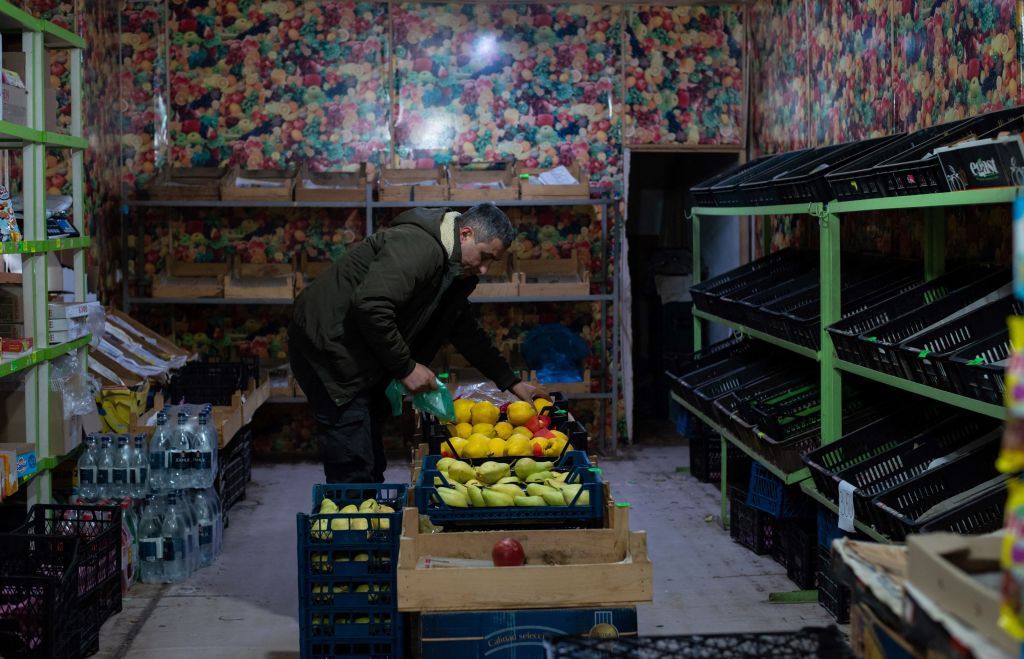 A man holds fruit in an empty market in Stepanakert, the capital of Nagorno-Karabakh, on December 23, 2022. (Davit Ghahramanyan—AFP/Getty Images)