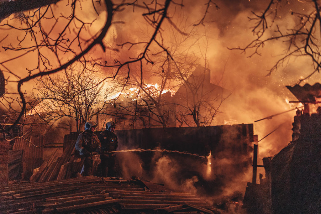 Emergency service workers extinguish a fire after shelling on the Bakhmut frontline in Ivanivske, Ukraine on Jan. 2, 2023. (Diego Herrera Carcedo—Anadolu Agency/Getty Images)
