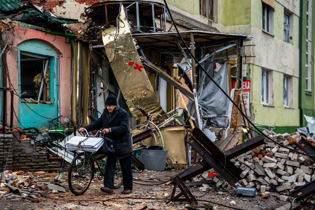 A local resident pushes his bicycle past "hedgehog" tank traps and rubble, down a street in Bakhmut, Donetsk region, on Jan. 6, 2023. (Dimitar Dilkoff—AFP via Getty Images)