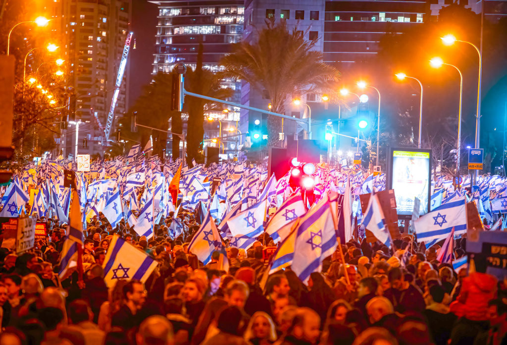 Crowd of protesters wave flags and placards during the demonstration. Thousands of protesters rally for Democracy in Tel Aviv for the Fifth Consecutive Week across Israel. (Eyal Warshavsky-SOPA Images/LightRocket)