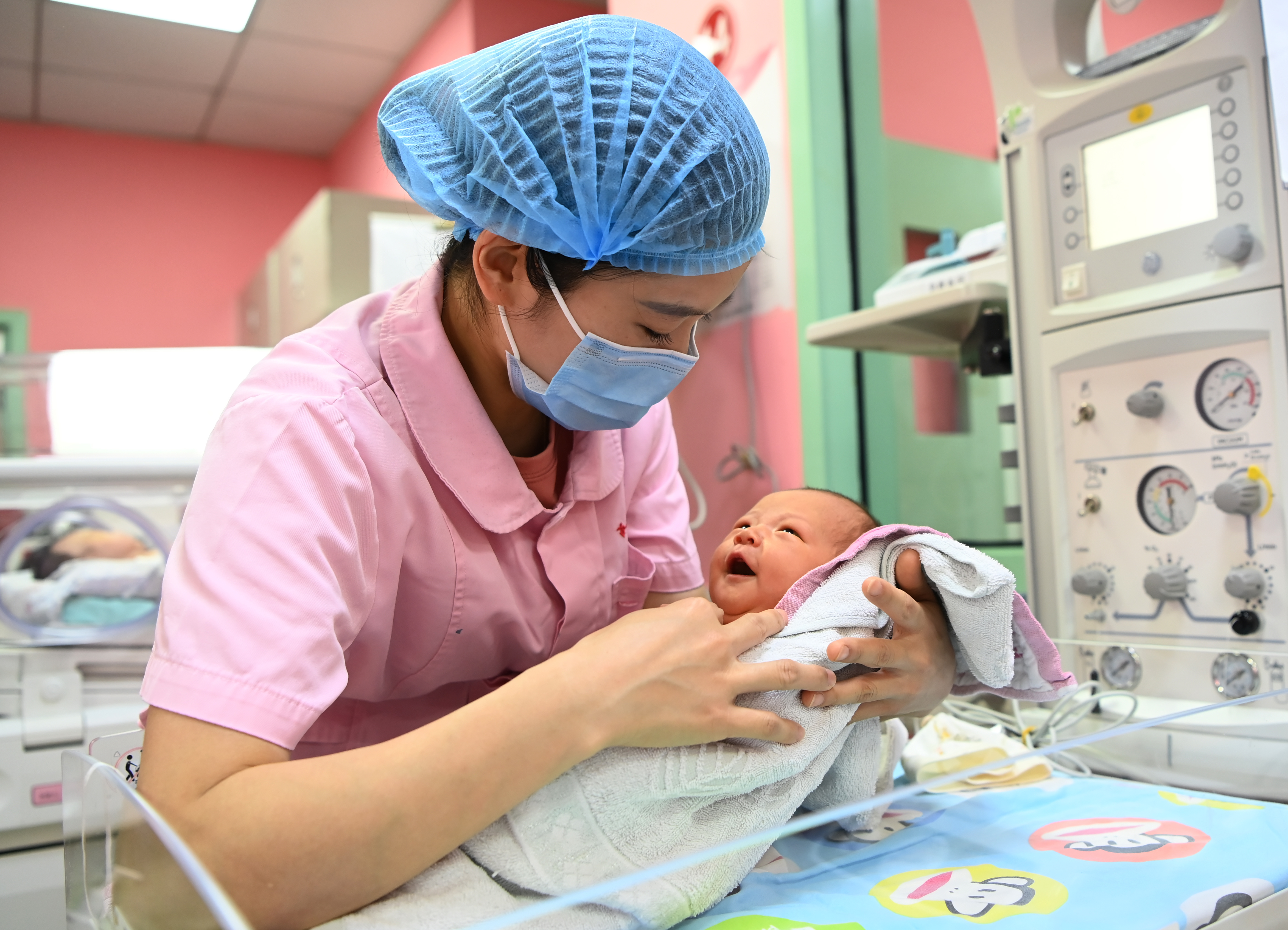 A nurse holds a newborn at a hospital in Chengdu, the capital of the Chinese province of Sichuan, on May 11, 2021. Starting Feb. 15, 2023, there will no longer be a limit on the number of childbirths a person can register in Sichuan. (An Yuan—China News Service/Getty Images)