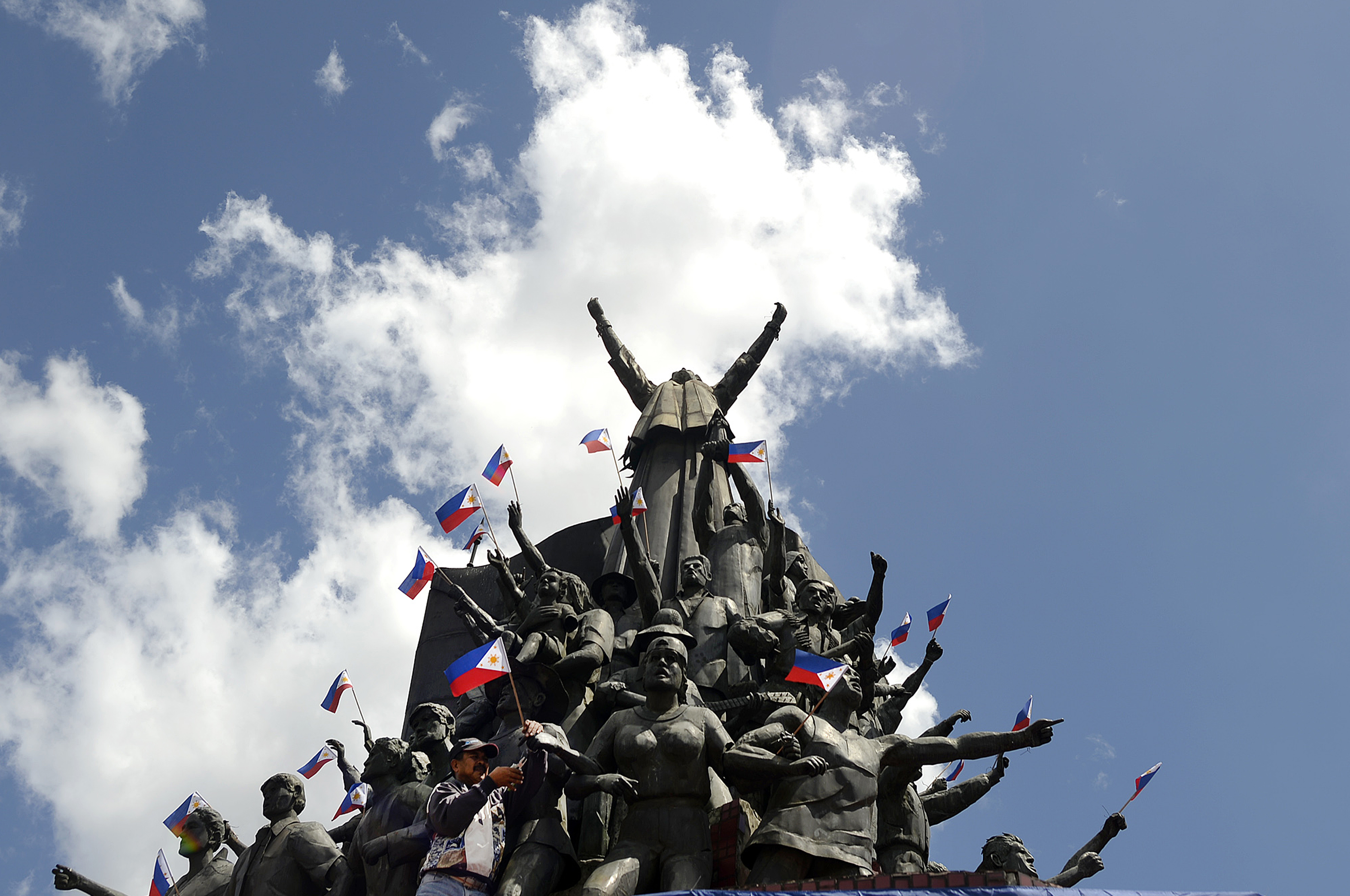 Philippine flags adorn the People Power Monument in Manila for the 30th anniversary in 2016 of the revolution that ended the Ferdinand Marcos dictatorship. With Marcos Jr. now president, some worry the past is at risk of being forgotten. (Noel Celis—AFP/Getty Images)