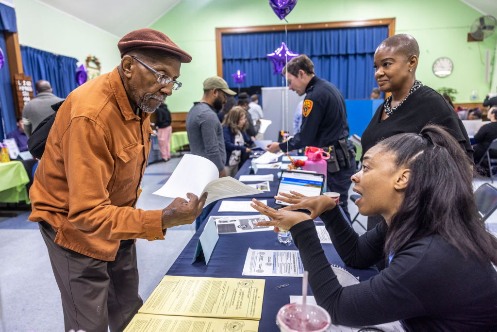 Job seekers talk with potential employers during a job fair at the Wyandanch Community Resource Center in Wyandanch, N.Y. on Sept. 30, 2022. (Alexandra Villa Loarca—Newsday RM/Getty Images)