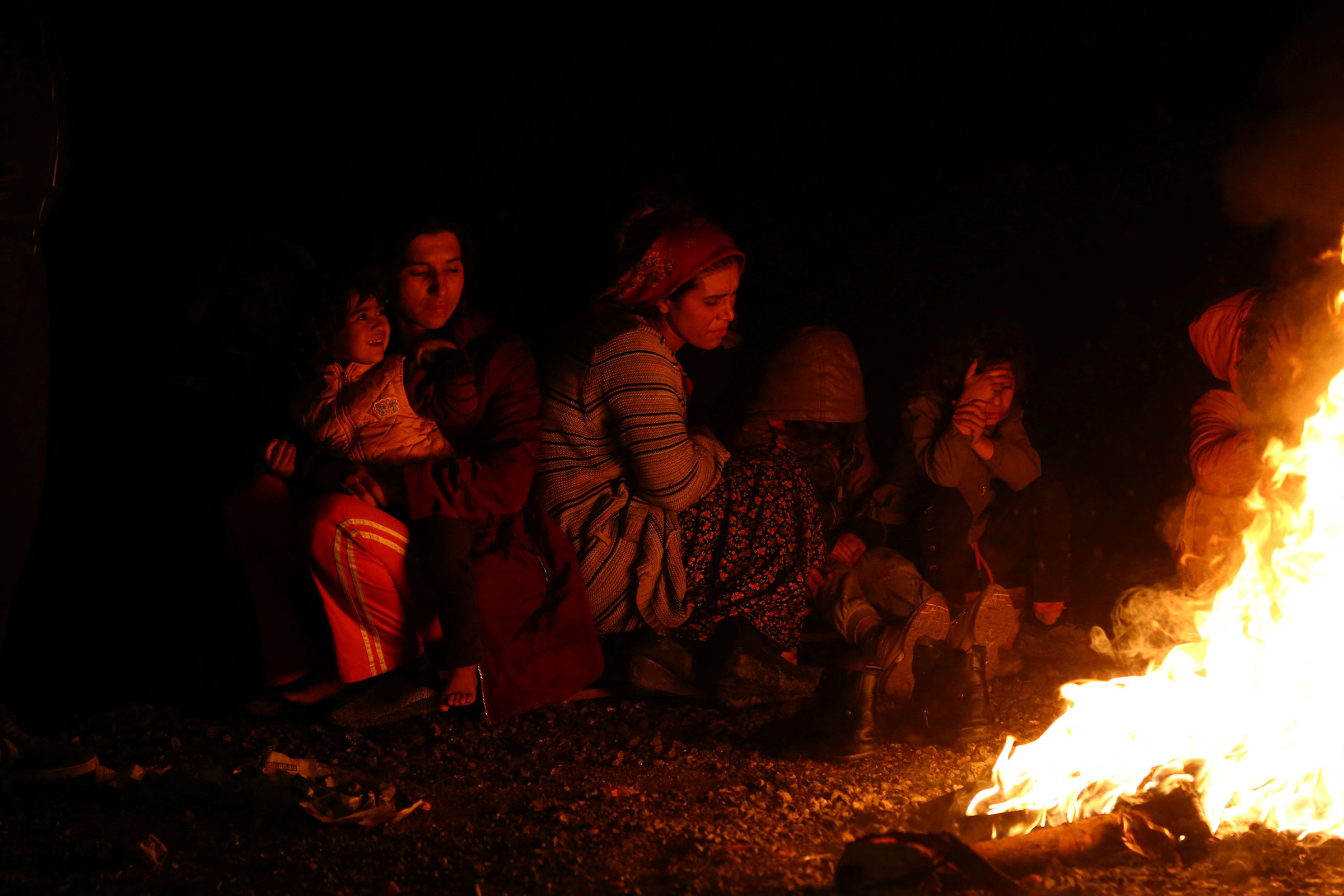 People gather around a bonfire following an earthquake in Kahramanmaras, Turkey on Feb. 6, 2023. (Cagla Gurdogan—Reuters)