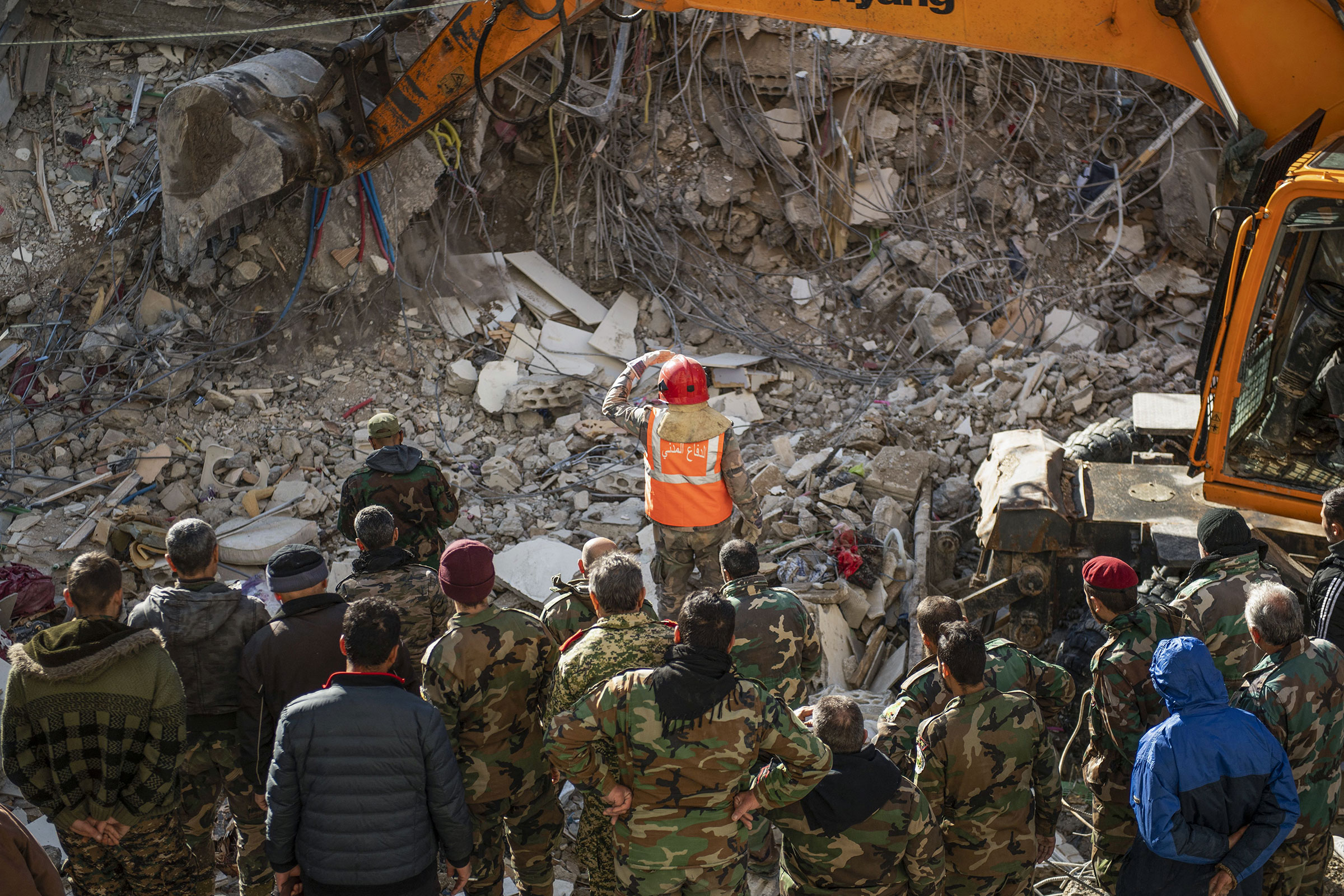 Rescue workers search for survivors in the rubble of a collapsed building in the town of Jableh in Syria's northwestern province of Latakia following an earthquake, on Feb. 7, 2023. (AFP/Getty Images)