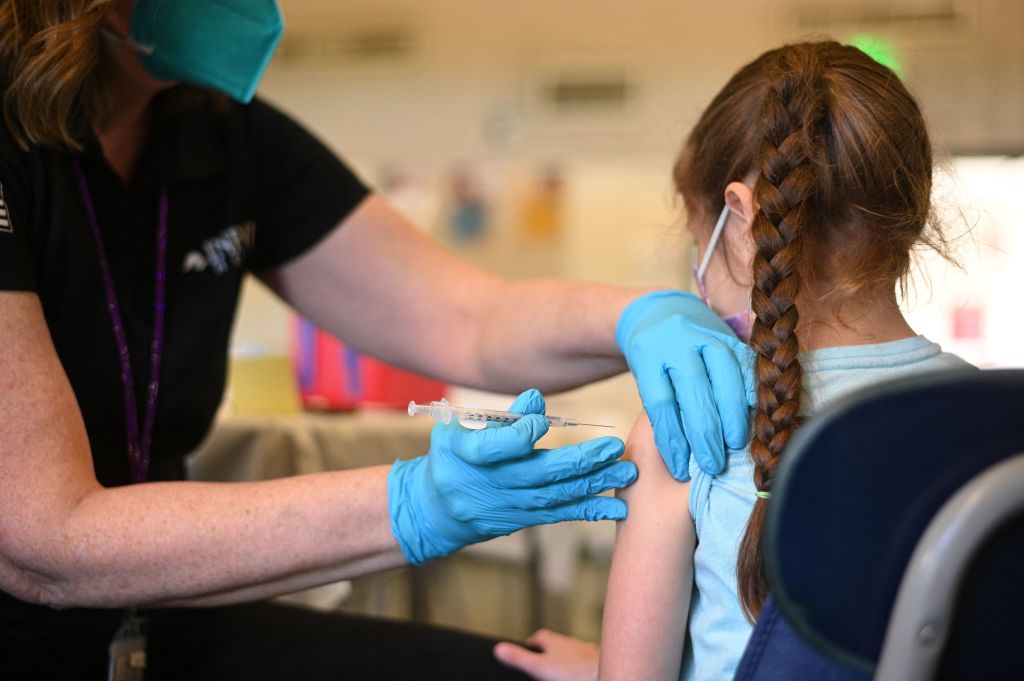 A nurse administers a pediatric dose of the COVID-19 vaccine to a girl at a L.A. Care Health Plan vaccination clinic at Los Angeles Mission College on Jan. 19, 2022. (Robyn Beck—AFP/Getty Images)