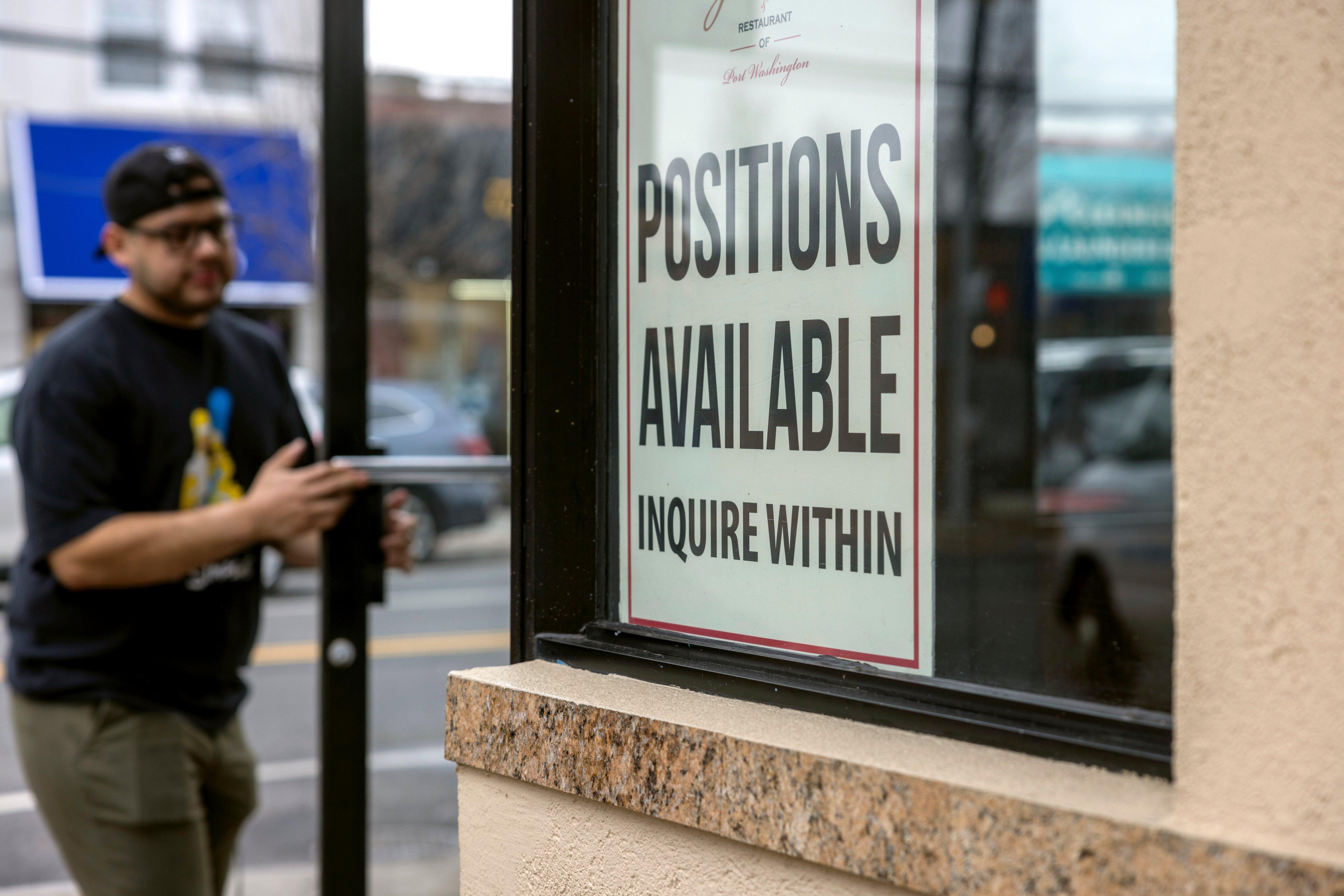 A 'help wanted' sign seeking workers is on a window at Gino's Pizzeria Restaurant in Port Washington, N.Y. (Howard Schnapp–Newsday RM via Getty Images)