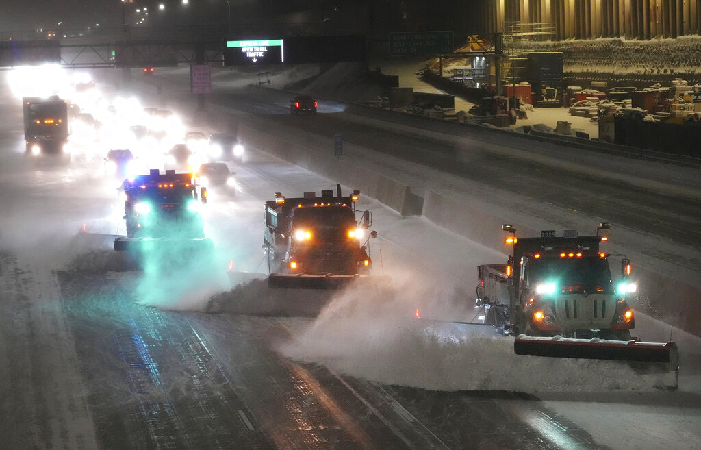 Snow plows move snow from I-35W southbound, seen from the 42nd St. Bridge, as the metro and much of the state prepares for a winter storm, on Wednesday, Feb. 22, 2023 in Minneapolis. (David Joles–Star Tribune/AP)