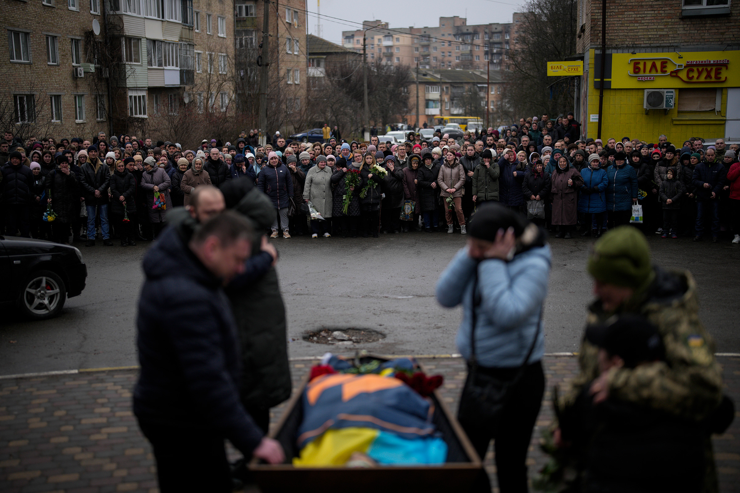 Bucha relatives gather to mourn the body of Oleksiy Zavadskyi, a Ukrainian serviceman who died in combat on Jan. 15 in Bakhmut, during his funeral in Bucha, Ukraine, Jan. 19, 2023. (Daniel Cole—AP)