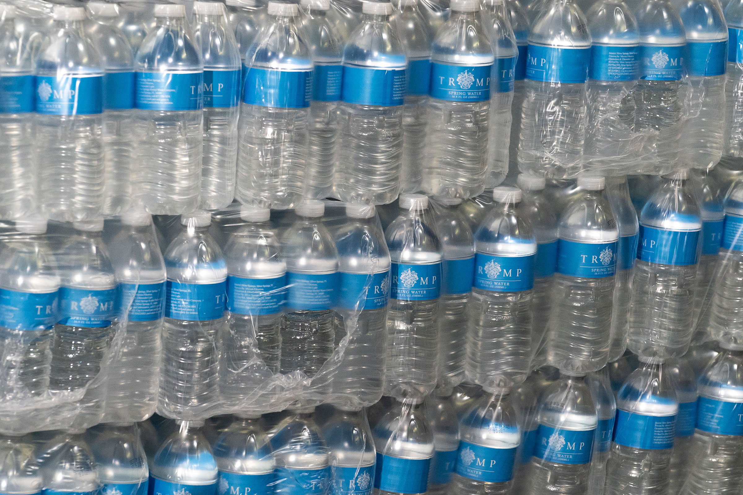 Cases of water labeled Trump Spring Water, are displayed prior to Former President Donald Trumps remarks to the press at the East Palestine Fire Department. (Michael Swensen—Getty Images)