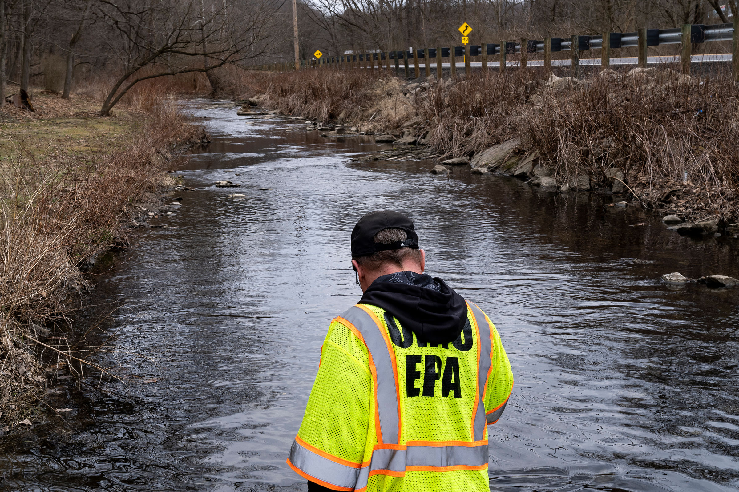 Ron Fodo, Ohio EPA Emergency Response, looks for signs of fish and also agitates the water in Leslie Run creek to check for chemicals that have settled at the bottom following a train derailment that is causing environmental concerns in East Palestine, on Feb. 20, 2023. (Michael Swensen—Getty Images)