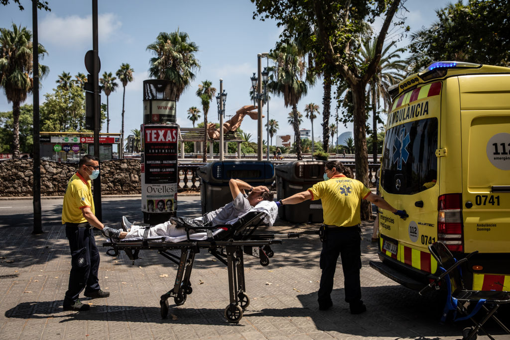 Paramedics help a patient into an ambulance during a heat wave in Barcelona, Spain, on July 18, 2022. The heat wave killed 360 people dead in Spain between July 10 and 15, Instituto de Salud Carlos III said. Photographer: Angel Garcia/Bloomberg via Getty Images (Angel Garcia/Bloomberg—Getty Images)