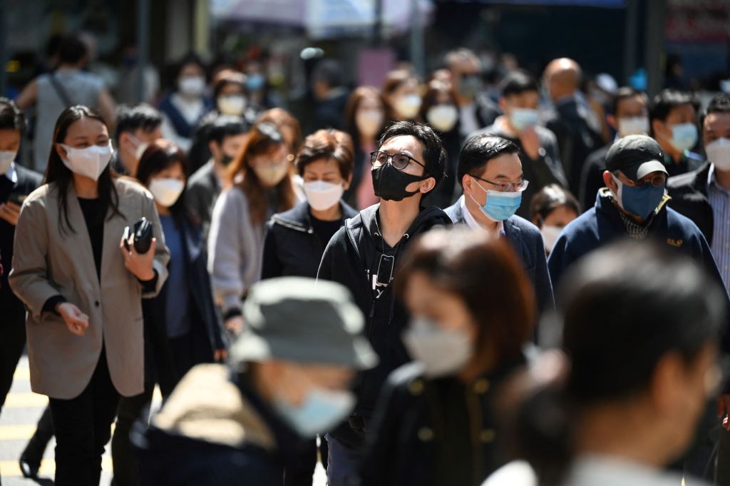 People wear masks on a street in Hong Kong on February 27, 2023. (Peter Parks–AFP/Getty Images)