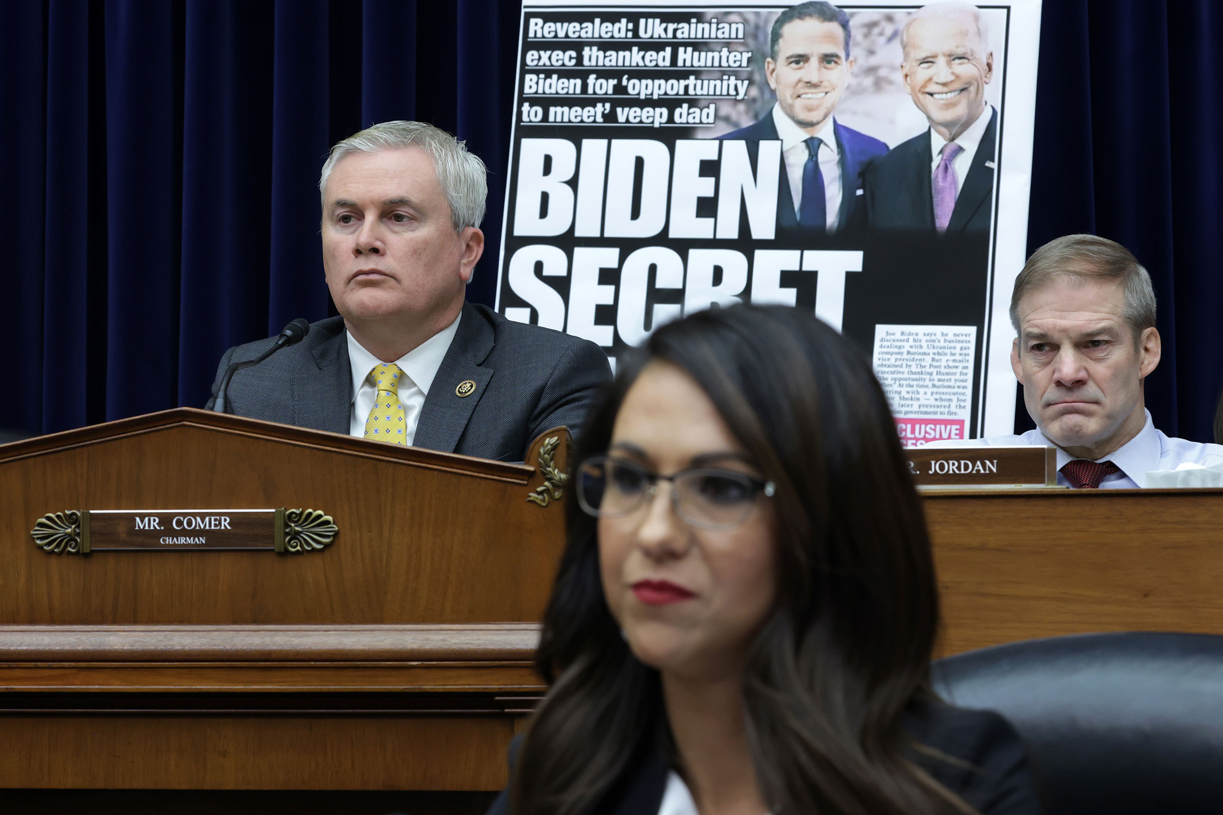 With a poster of a New York Post front page story about Hunter Biden’s emails on display, Committee Chairman Rep. James Comer (R-KY), Rep. Jim Jordon (R-OH) and Rep. Lauren Boebert (R-CO) listen during a hearing before the House Oversight and Accountability Committee at Rayburn House Office Building on Capitol Hill on Feb. 8, 2023.
