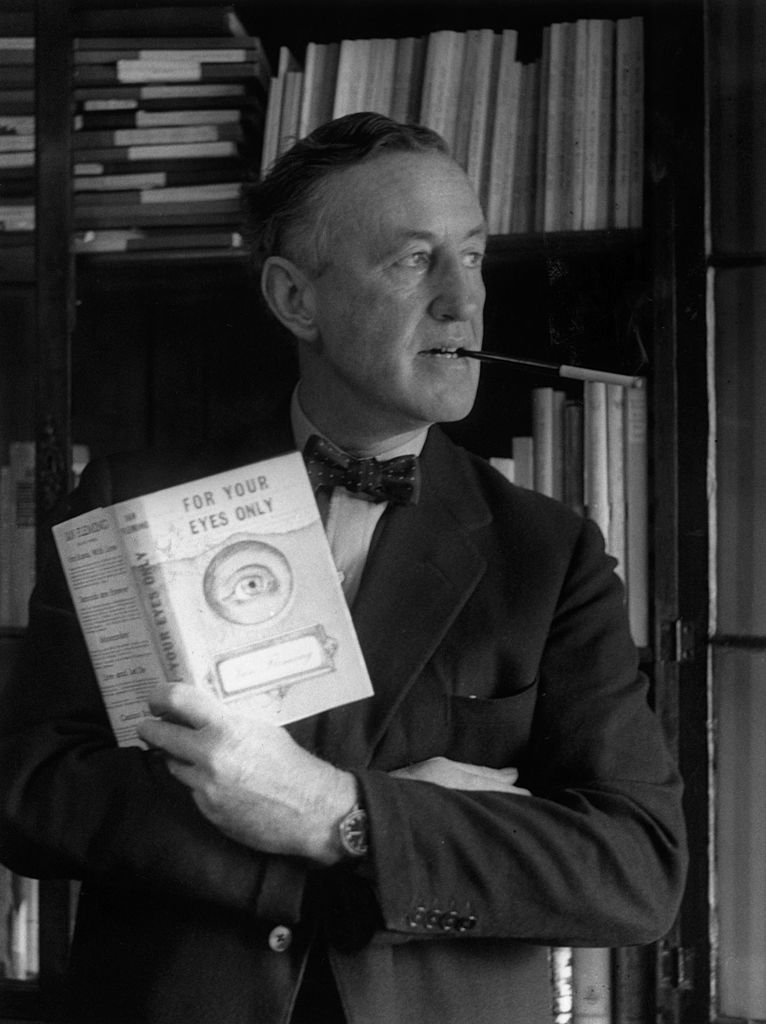 English author Ian Fleming (1908 - 1964) in his study with a copy of 'For Your Eyes Only', one of the series of James Bond novels that he wrote.