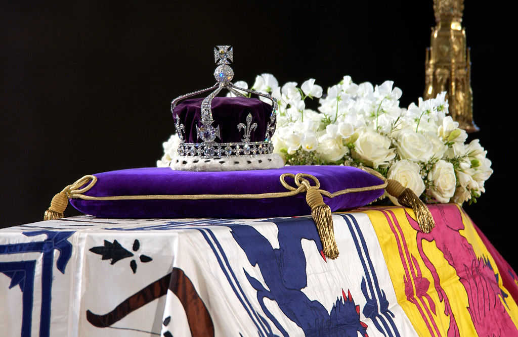 A close-up of the Queen Mother's coffin, the wreath of white flowers and the Queen Mother's coronation crown with the priceless Koh-I-Noor diamond.