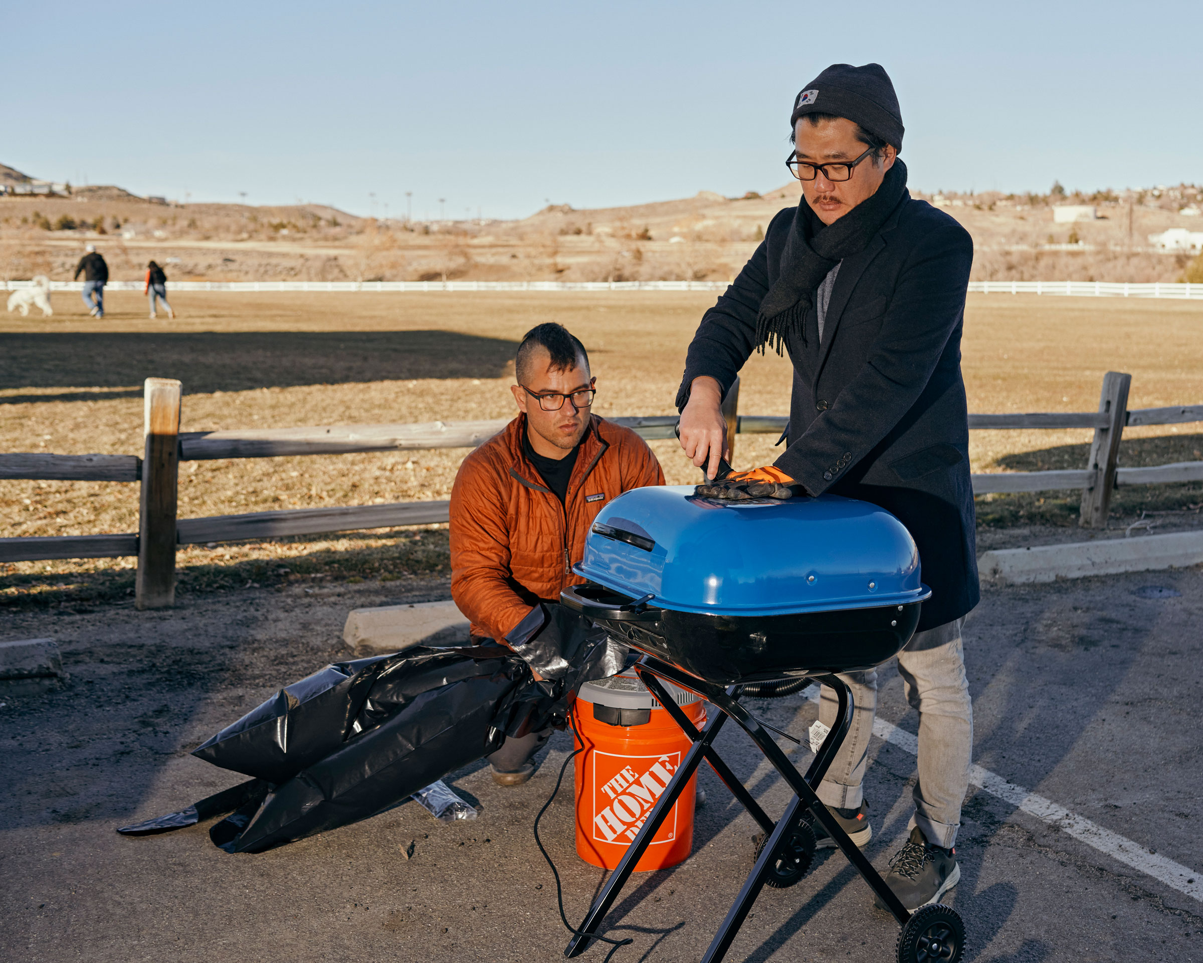Founder Luke Iseman and co-founder Andrew Song of solar geoengineering startup Make Sunsets use a grill to burn sulfate powder and capture the generated gases in a plastic bag at a park in Reno, Nevada, United States on February 12, 2023.