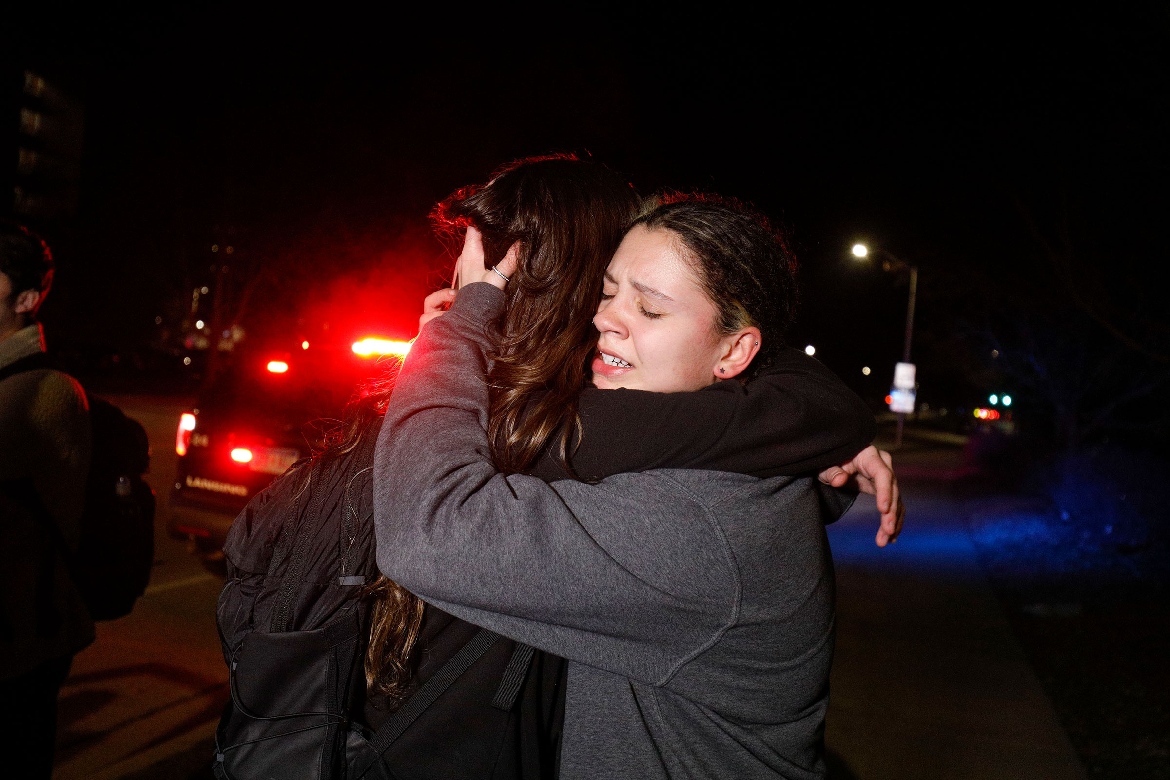 Michigan State University students hug during an active shooter situation on campus in Lansing, on Feb. 13, 2023. (Bill Pugliano—Getty Images)