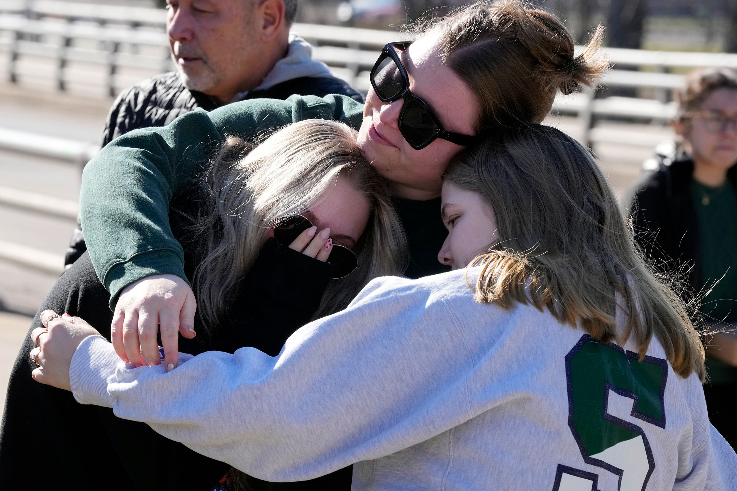 Michigan State University students embrace at The Rock on campus, in East Lansing, Mich. on Feb. 14, 2023. (Carlos Osorio—AP)
