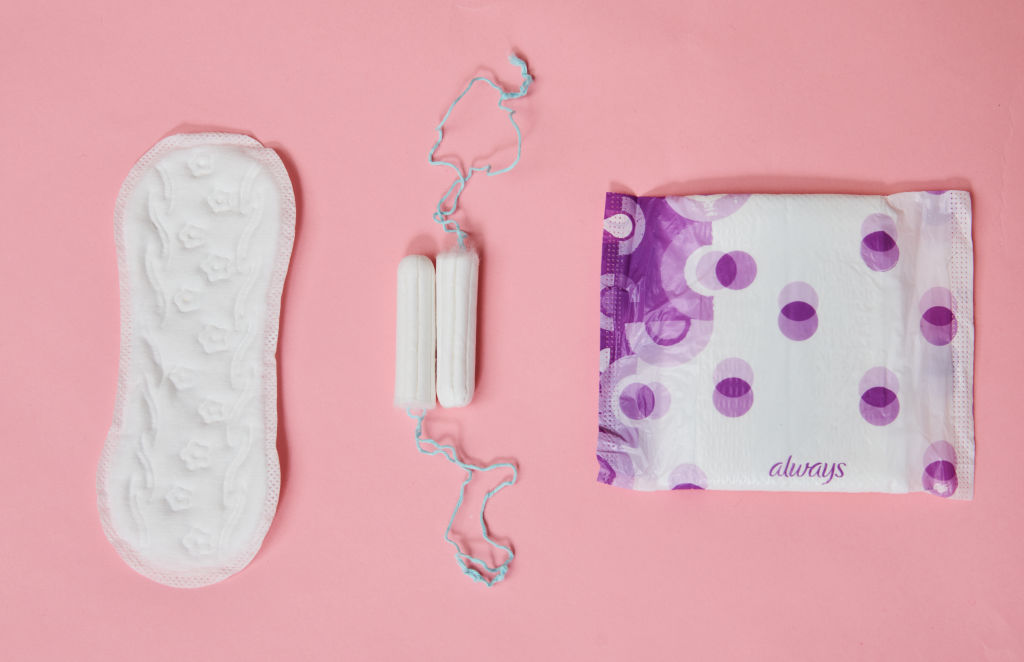 Tampons, a panty liner, and a sanitary napkin from different manufacturers are on one table. (Annette Riedl/picture alliance—Getty Images)