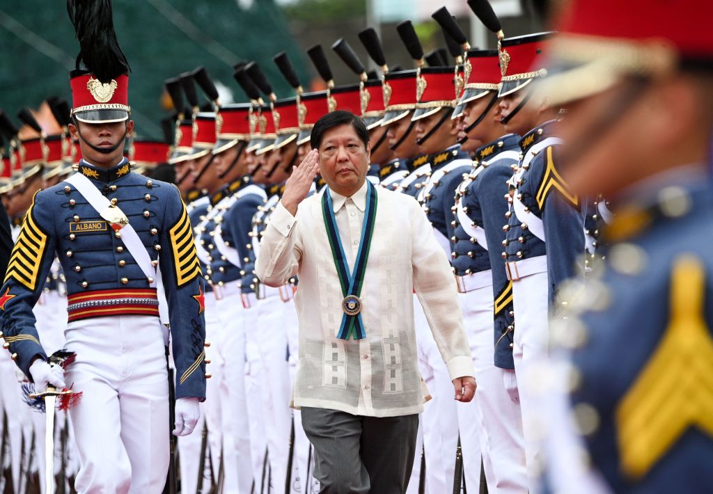 Philippine President Ferdinand Marcos Jr. (C) salutes as he troops the line during the 87th anniversary celebration of the Armed Forces of the Philippines, at the military headquarters in suburban Manila on Dec. 19, 2022. (Photo by (Ted Aljibe—AFP/Getty Images)