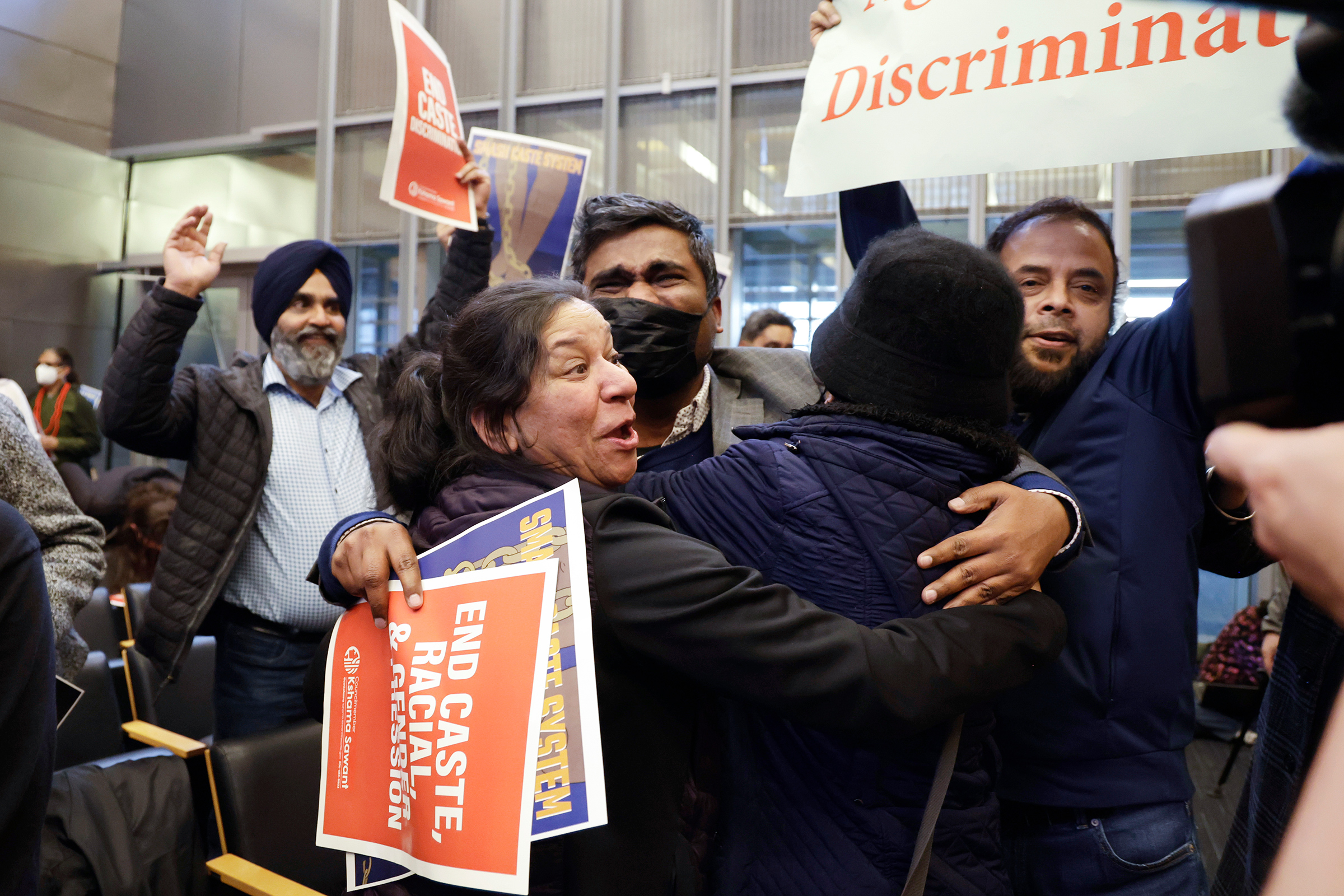 People celebrate the passing of an ordinance to add caste to Seattle's anti-discrimination laws in the Seattle City Council chambers on Feb. 21. (John Froschauer—AP)