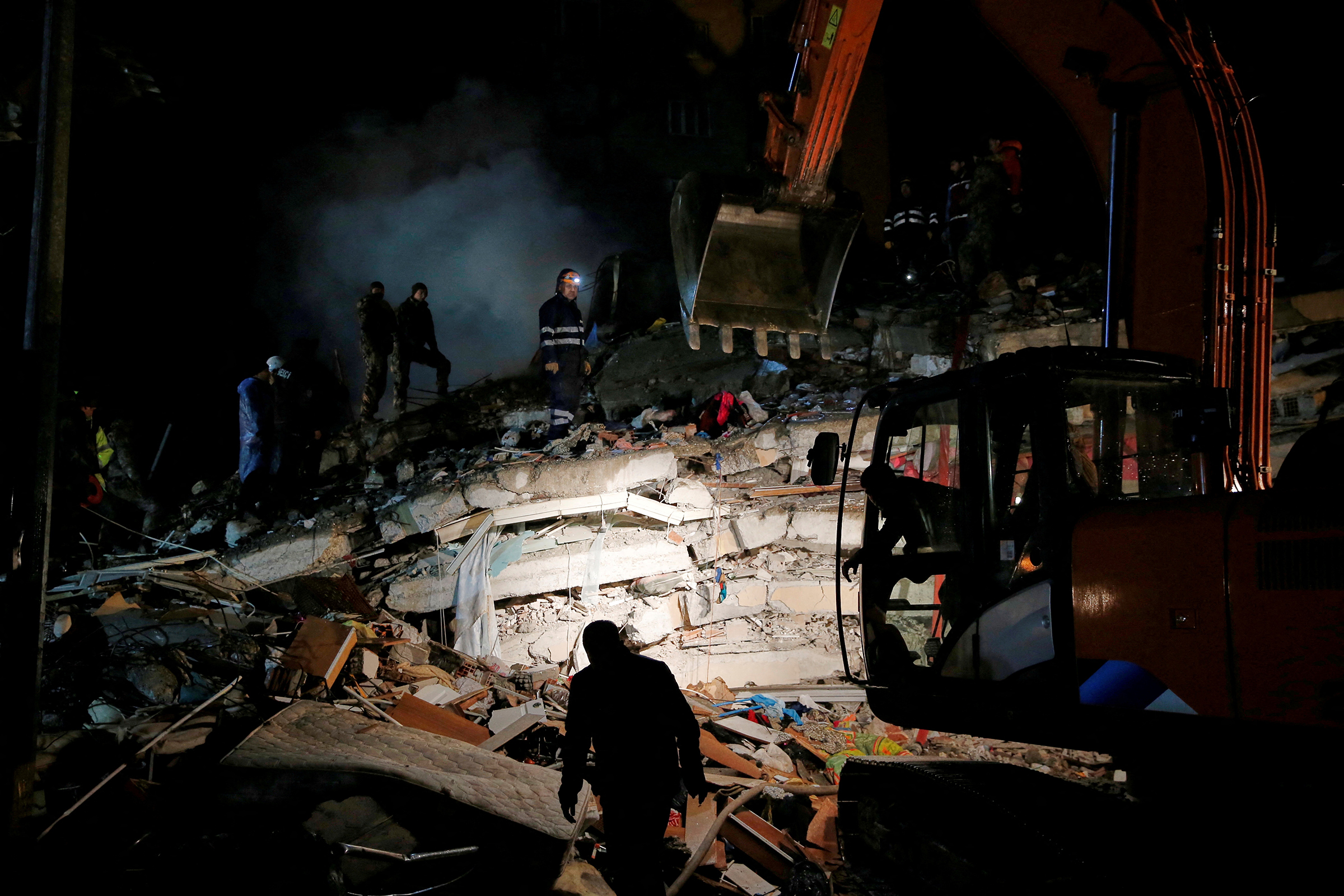 A rescue team works on a collapsed building following an earthquake in Osmaniye, Turkey, on Feb. 6. (Dilara Senkaya—Reuters)