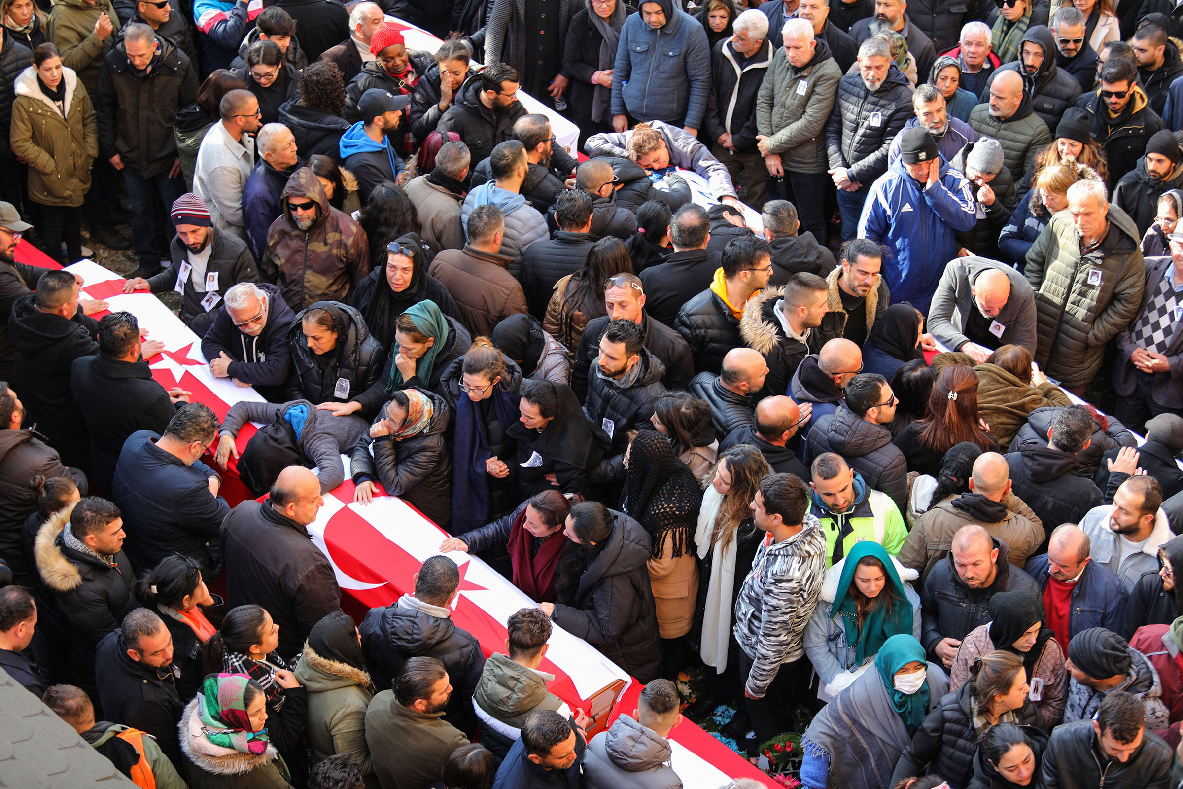 People mourn by their relative's coffin during the funeral of Cypriot students killed in an earthquake that hit Turkey, in the eastern city of Famagusta, in the breakaway Turkish Cypriot statelet of northern Cyprus, on Feb. 11, 2023. (Birol Bebek—AFP/Getty Images)