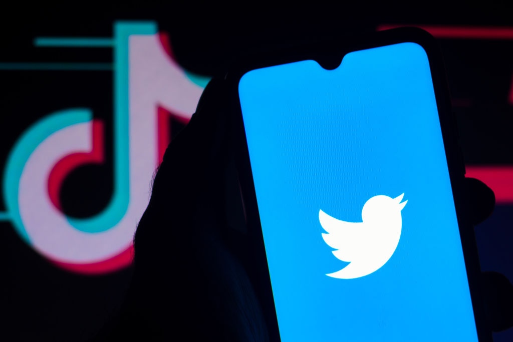 In this photo illustration the Twitter logo is seen displayed on a smartphone with the TikTok logo in the background. (Rafael Henrique/SOPA Images/LightRocket via Getty Images)