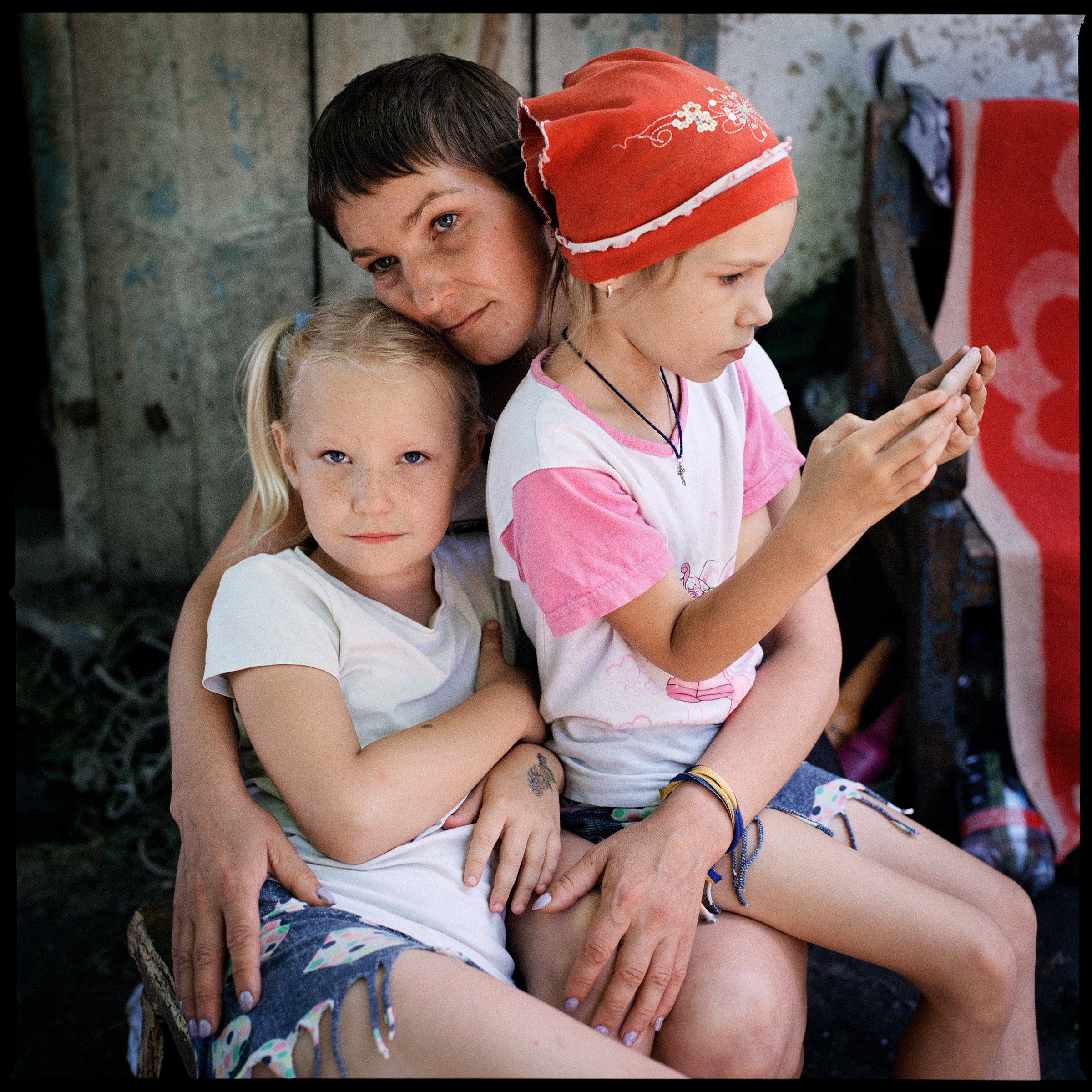 Olga Grinik, her daughter Miroslava, left, and her niece's daughter Angelina Drobysh, right, in Poltava region, where the family fled to escape the war, on June 29, 2022. Avdiivka, the Grinik family's hometown, has seen fierce fighting. The family recently learned that their house has been destroyed, along with much of the town. (Anastasia Taylor-Lind)
