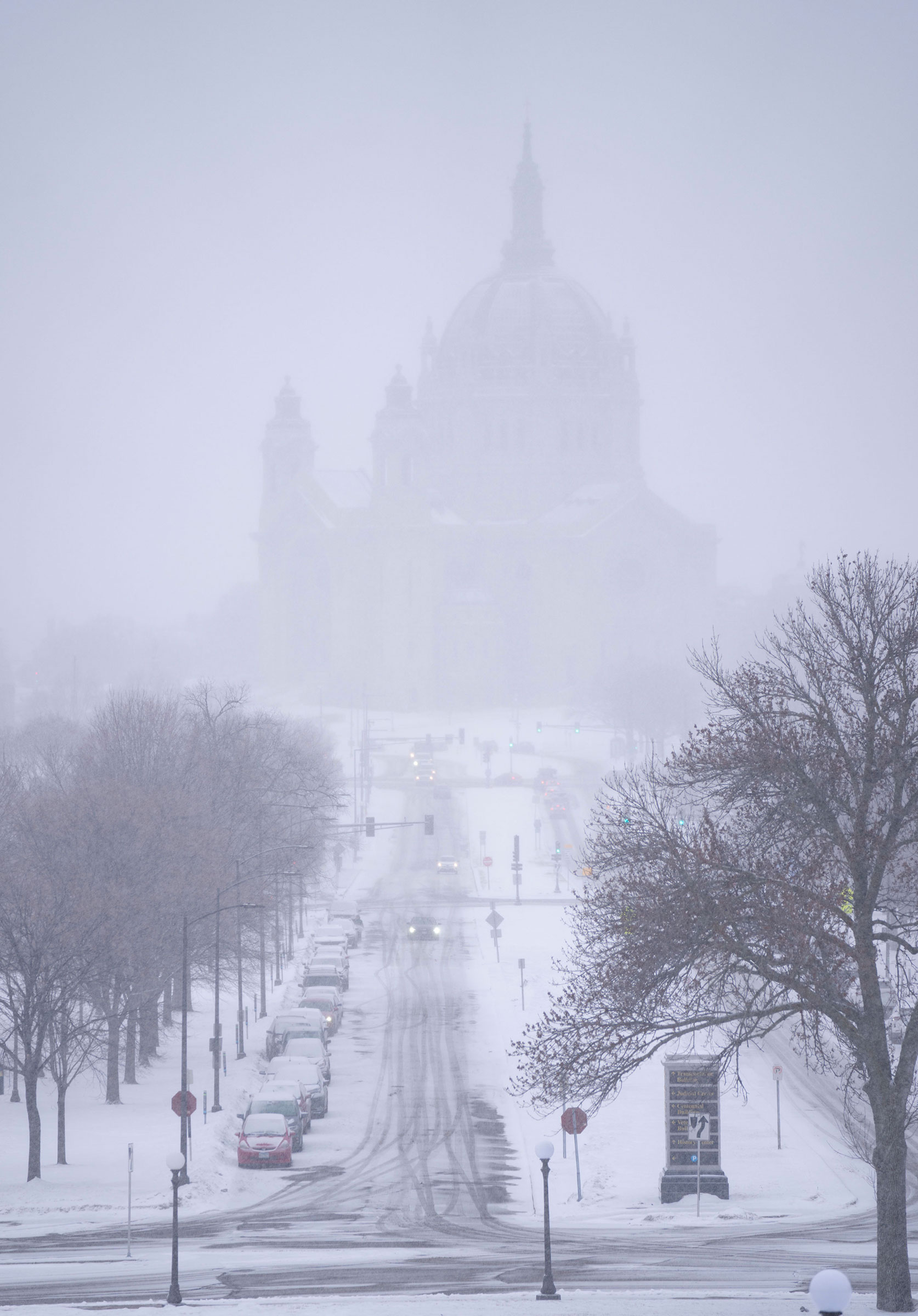 Snow begins to fall around the Cathedral of Saint Paul at the Minnesota State Capitol in St. Paul, Minn., on Feb. 21, 2023. (Alex Kormann—Star Tribune/AP)
