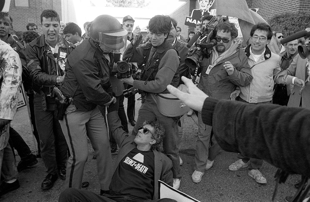 A man wearing a "Silence Equals Death" t-shirt at a protest organized by AIDS activist group ACT UP at the headquarters of the Food and Drug Administration on Oct. 11, 1988 in Rockville, Md. The action, called "Seize Control of the FDA," shut down the FDA for the day. (Catherine McGann—Getty Images)