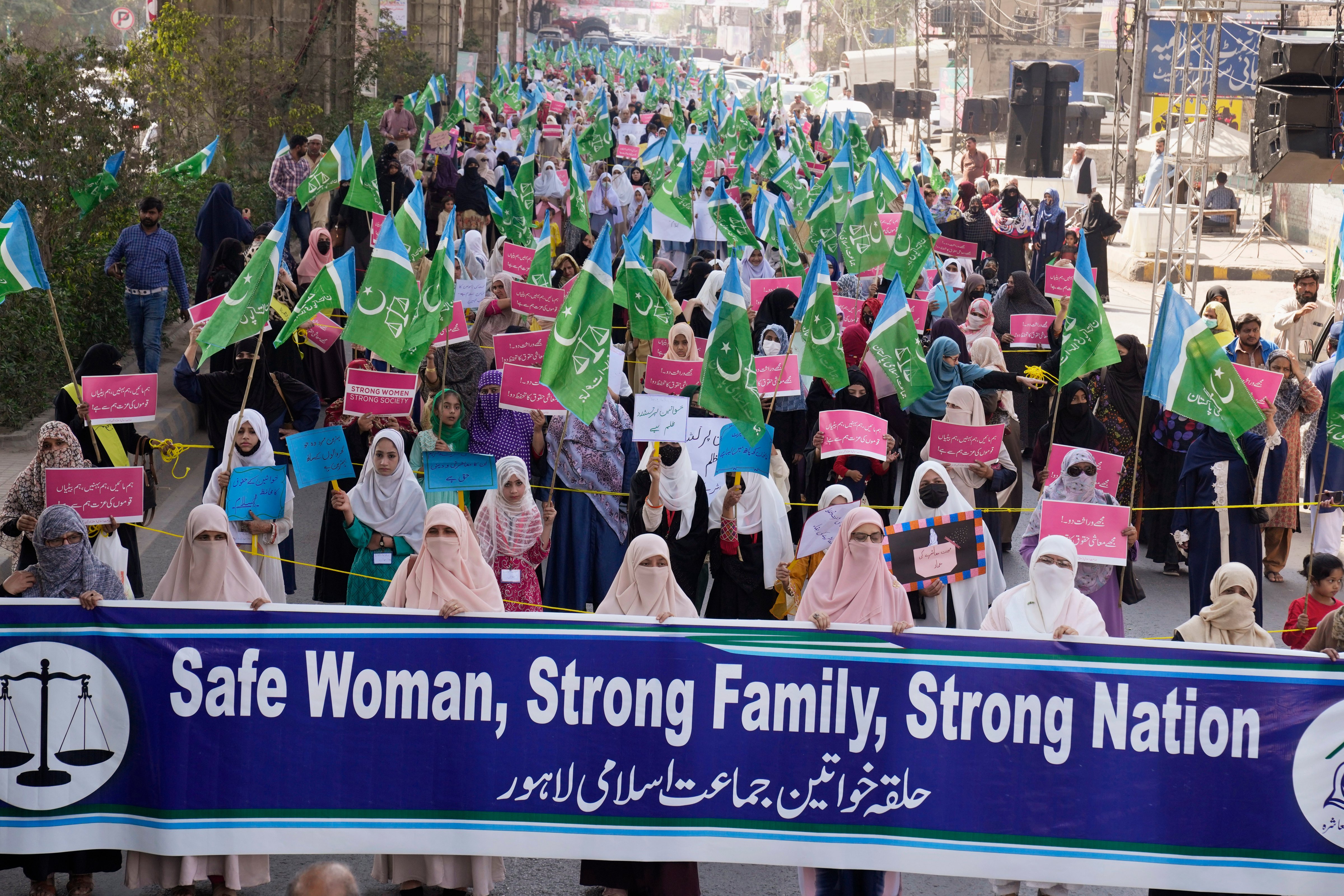 Women supporters of a religious party "Jamaat-e-Islami" participate in a rally to mark International Women's Day, in Lahore, Pakistan, Wednesday, March 8, 2023. (AP Photo/K.M. Chaudary)