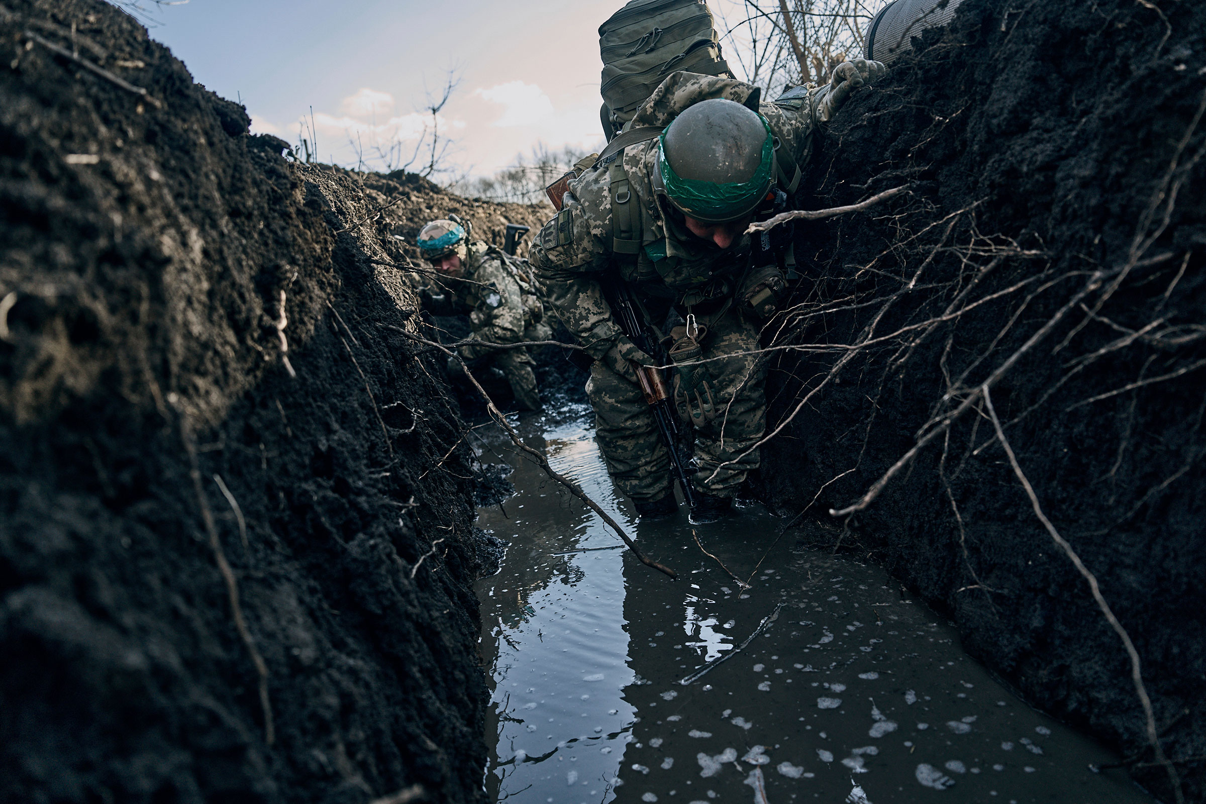 Ukrainian soldiers in a trench under Russian shelling on the frontline close to Bakhmut, on March 5, 2023. (Libkos—AP)