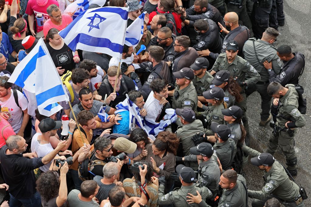 Israeli police confront protesters during ongoing demonstrations in Tel Aviv on March 23, 2023, against controversial legal reforms being touted by the country's hard-right government. (JACK GUEZ-AFP)
