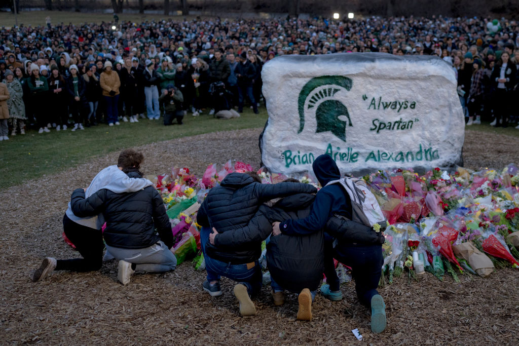 People embrace during the vigil at The Rock on Michigan State Universitys campus in East Lansing, Michigan on February 15, 2023. (The Washington Post/Getty Images)