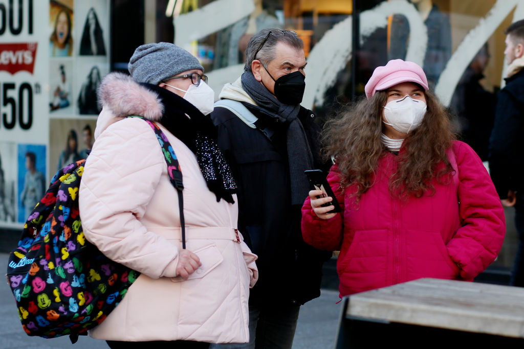 People wearing a masks walk through Times Square on March 6, 2023 in New York City. New York City police are urging businesses to require customers to remove face masks as a condition of entry due to a surge in robberies across the city. (Leonardo Munoz–VIEWpress/Getty Images)