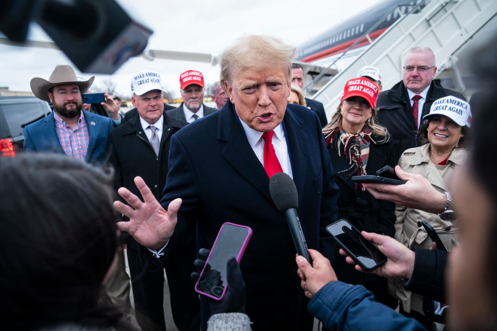 Former President Donald Trump speaks with reporters as he lands at Quad City International Airport in route to Iowa on March 13, 2023, in Moline, IL. (Jabin Botsford—The Washington Post/Getty Images)
