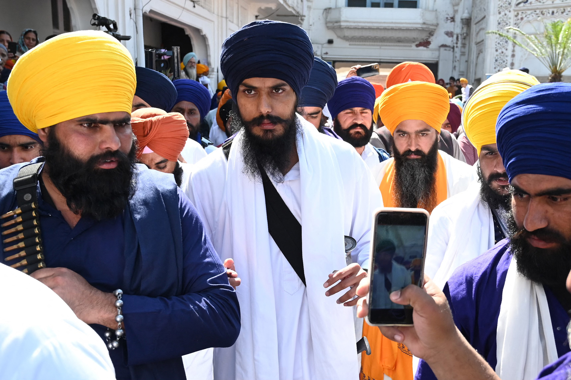 Amritpal Singh, center, pays his respect at the Golden Temple in Amritsar on March 3. (Narinder Nanu—AFP/Getty Images)