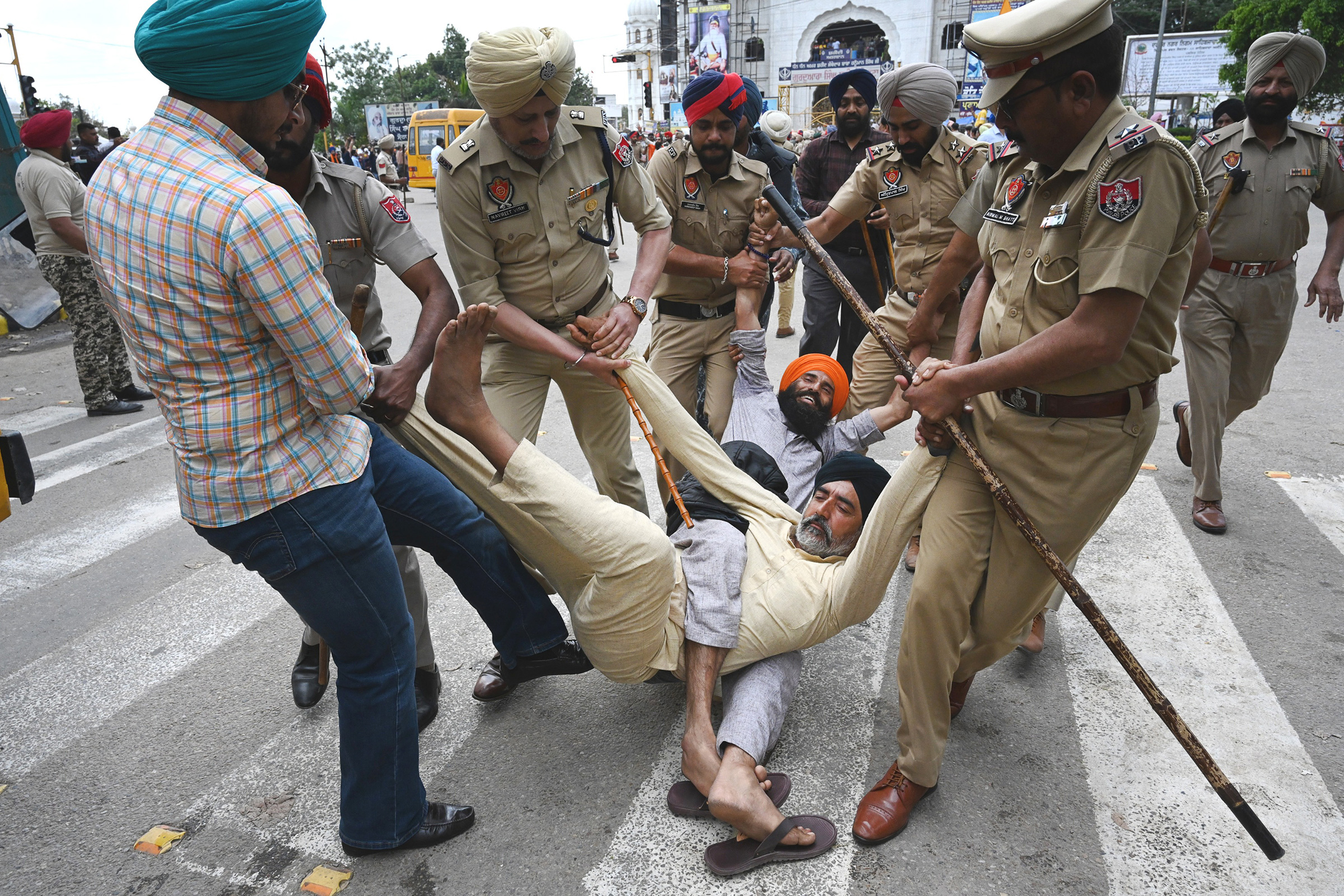 Punjab police forcefully remove supporters protesting the police action against Amritpal Singh in Mohali, India, on March 21. (Sanjeev Sharma—Hindustan Times/Getty Images)