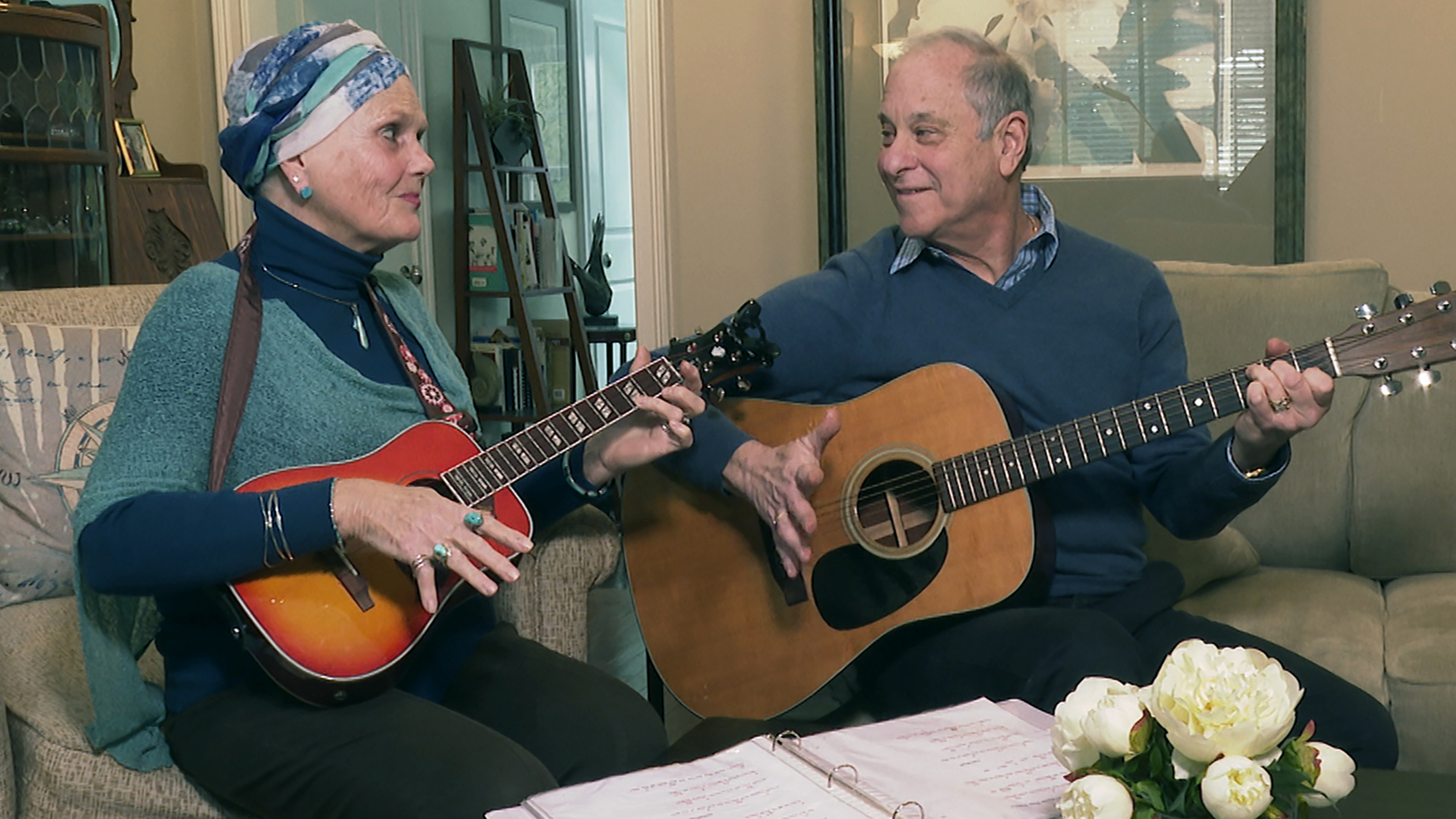 Lynda Shannon Bluestein, left, jams with her husband Paul in the living room of their home, Feb. 28, 2023, in Bridgeport, Conn. (AP Photo/Rodrique Ngowi))