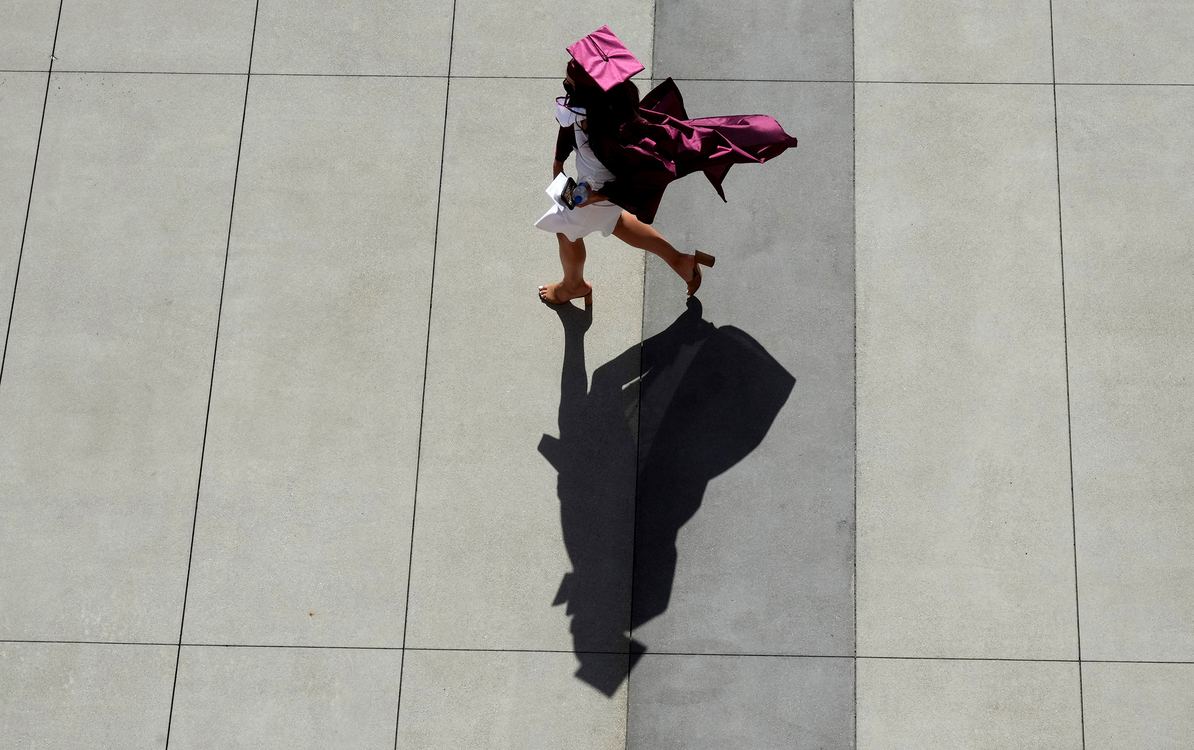 A graduate makes their way to the staging area during the 2021 Mt. Sac graduation in Walnut, Calif. on June 11, 2021. (Keith Birmingham—The Orange County Register/AP)