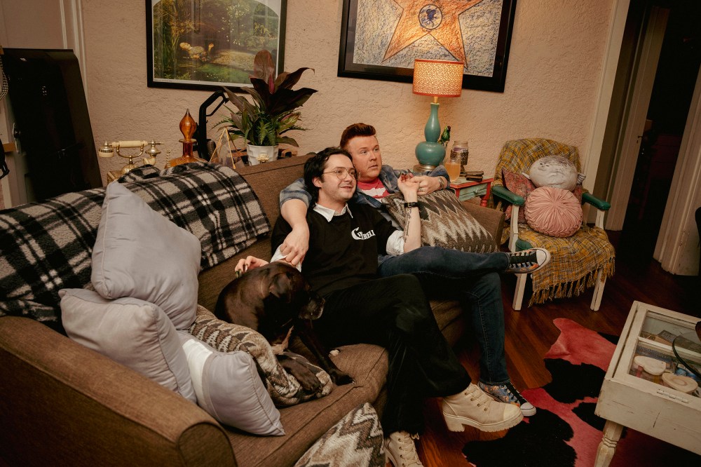Kelly McDaniel (right) and his husband Austin Wood-McDaniel (left) hang out in their living room after working their day jobs on March 29.