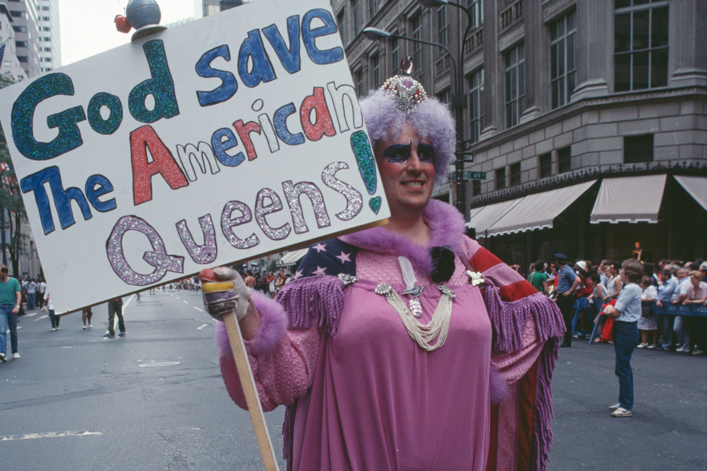 A drag queen holding a placard reading 'God save the American queens!' during the Pride Parade in New York City, June 1983. (Barbara Alper—Getty Images)