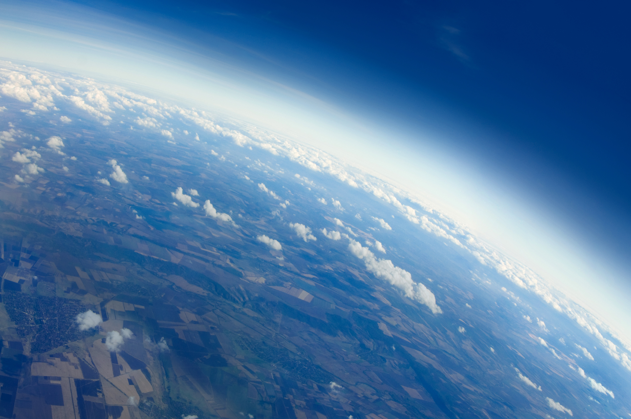 Aerial view of earth with clouds and the horizon.