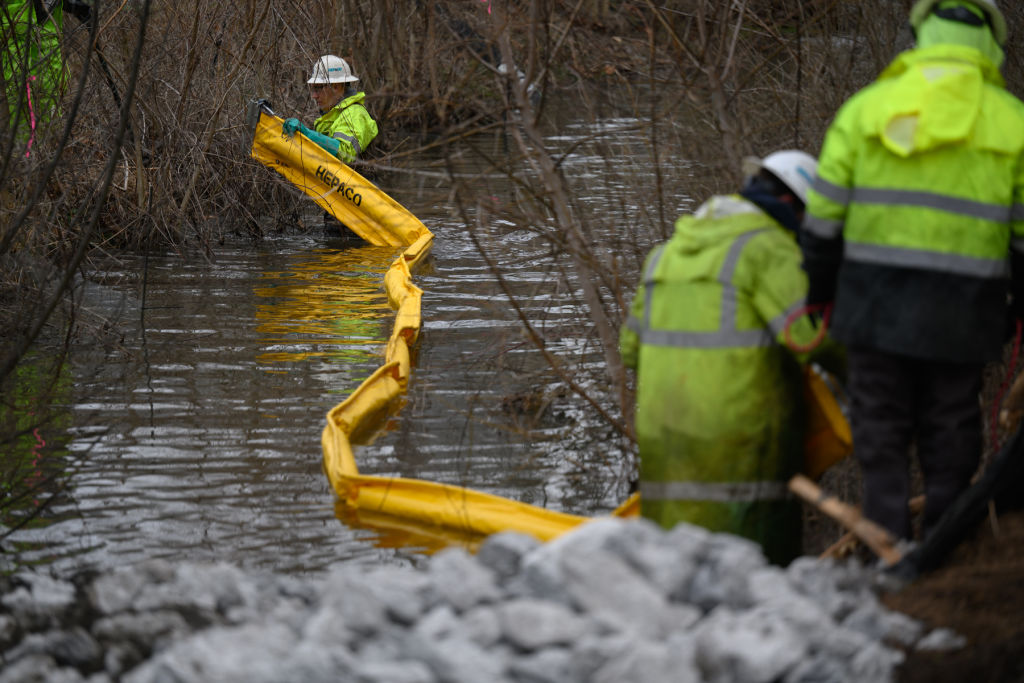 Contractors cleaning up and testing Sulphur Run, a creek that runs from the derailment site through the center of East Palestine, Ohio, on March 3, 2023. (Rebecca Kiger—The Washington Post/Getty Images)