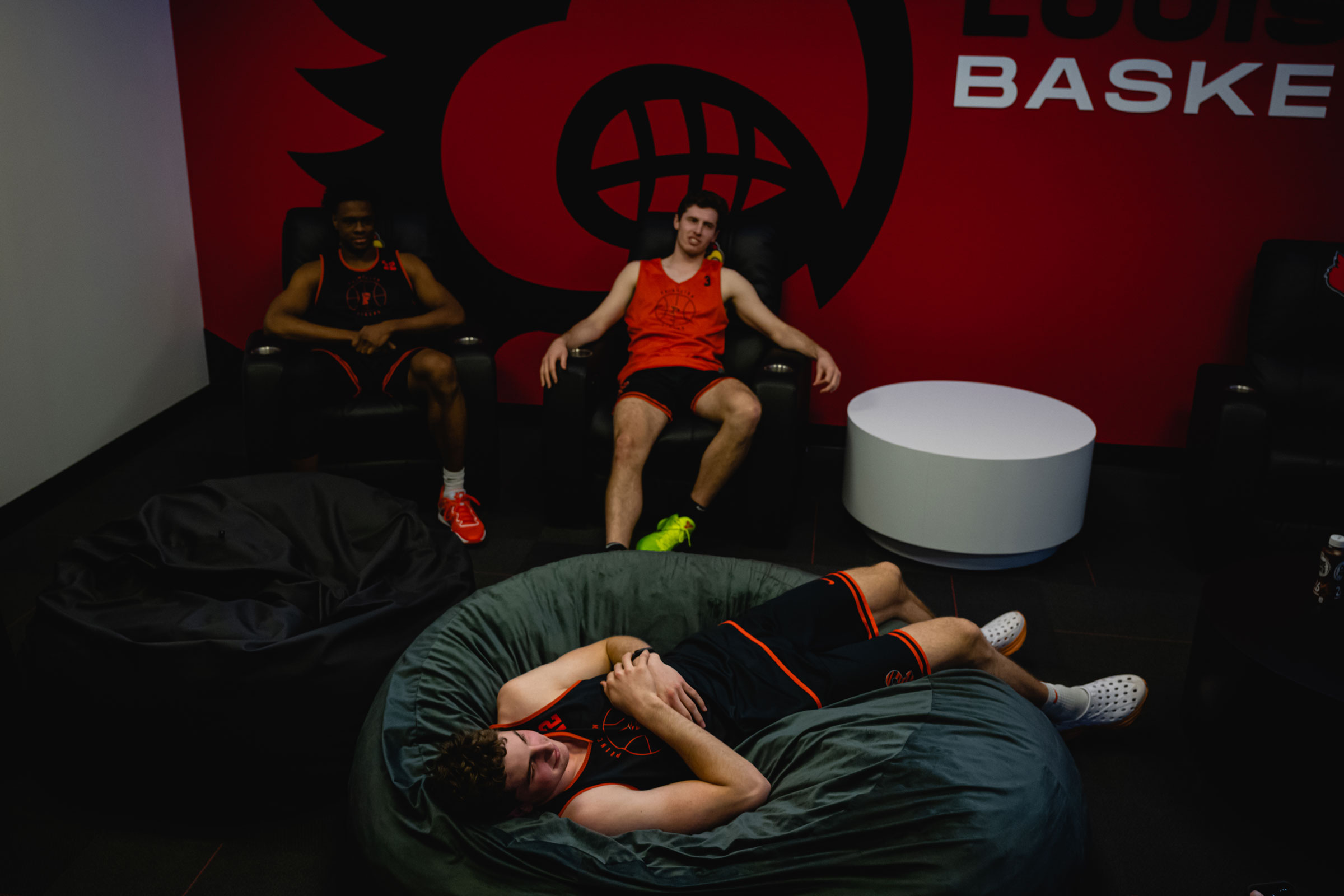 Keeshawn Kellman, Ryan Langborg, and Caden Pierce relax in a player's lounge at the KFC YUM! Center in Louisville, Kentucky on March 23, 2023.
