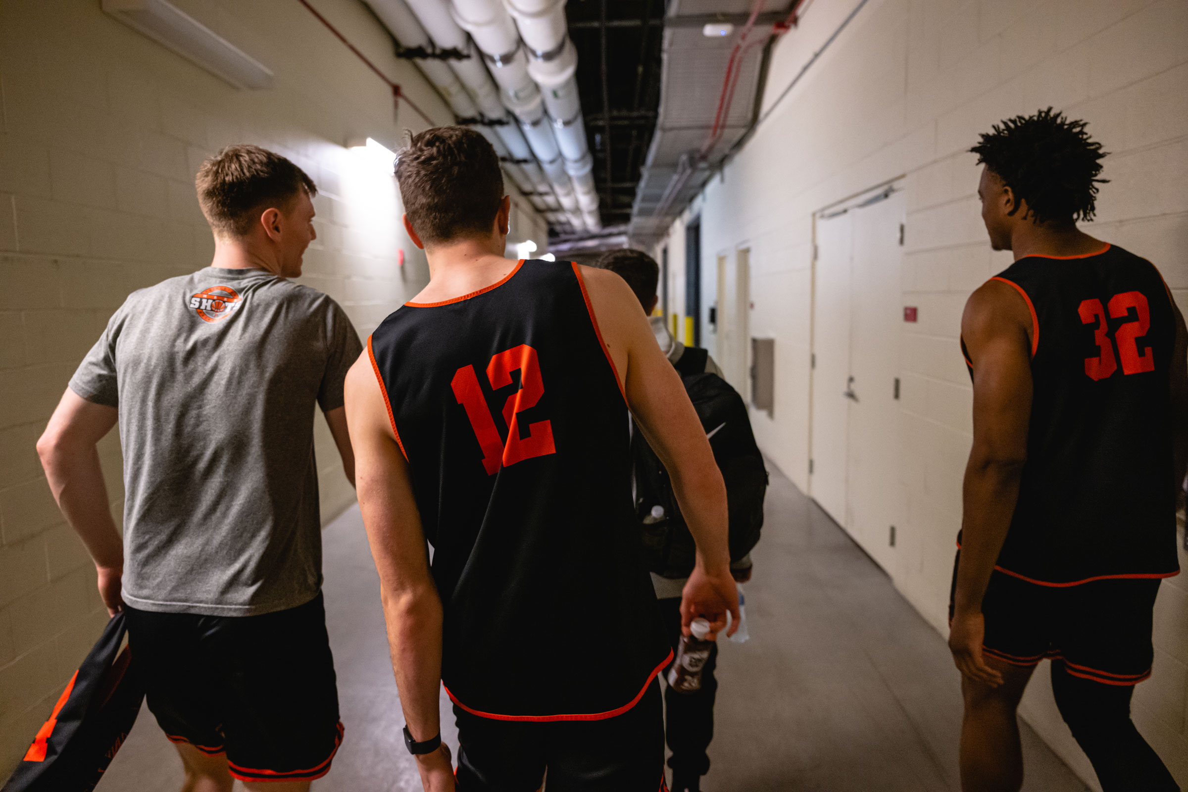 Blake Peters, Caden Pierce, and Keeshawn Kellman return to their locker room after a televised interview at the KFC YUM! Center in Louisville, Kentucky on March 23, 2023.