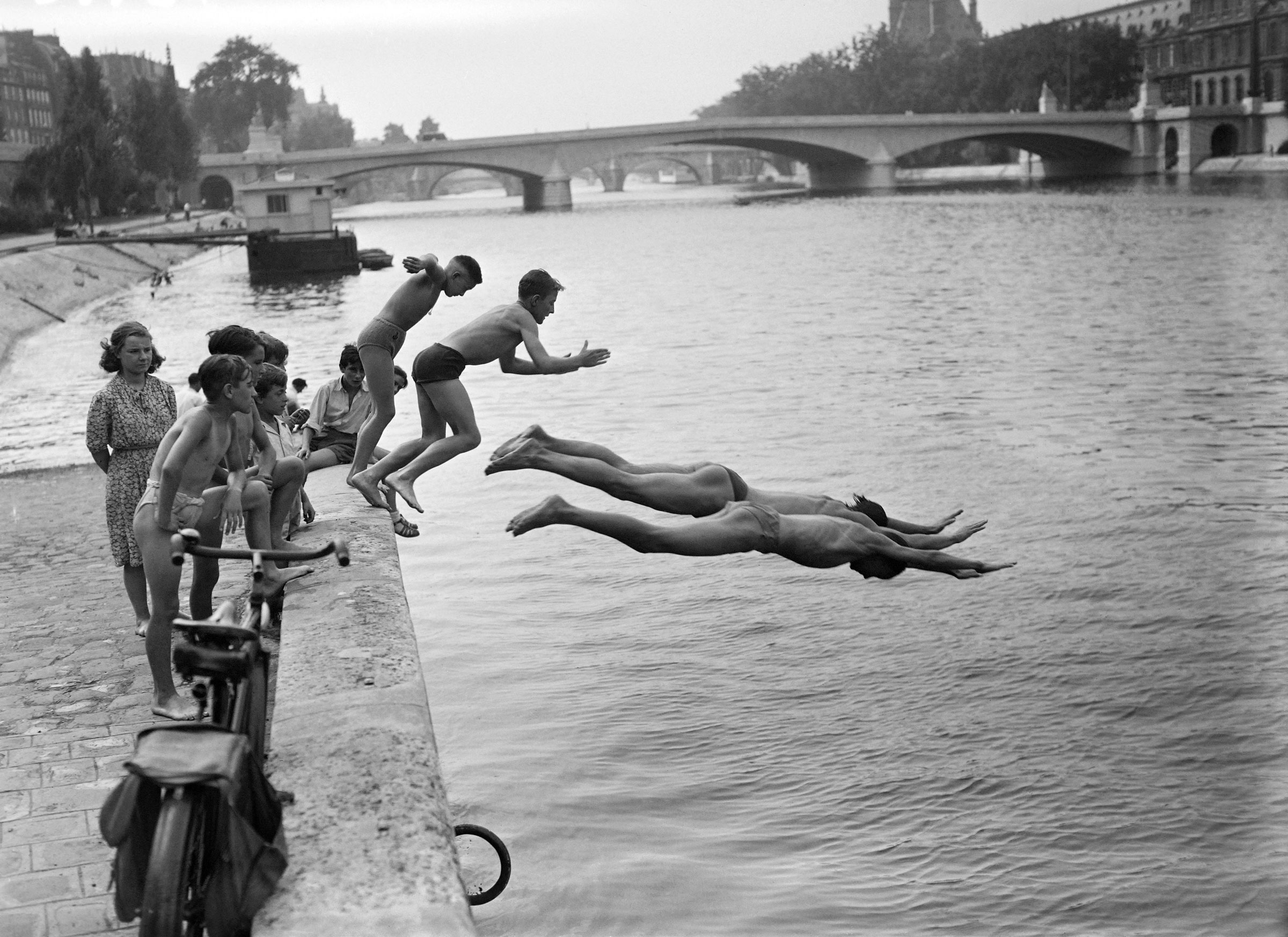 People dive into the Seine river near the Pont du Carrousel, in July 1949 in Paris, while a heat wave hits the capital. (AFP/Getty Images)