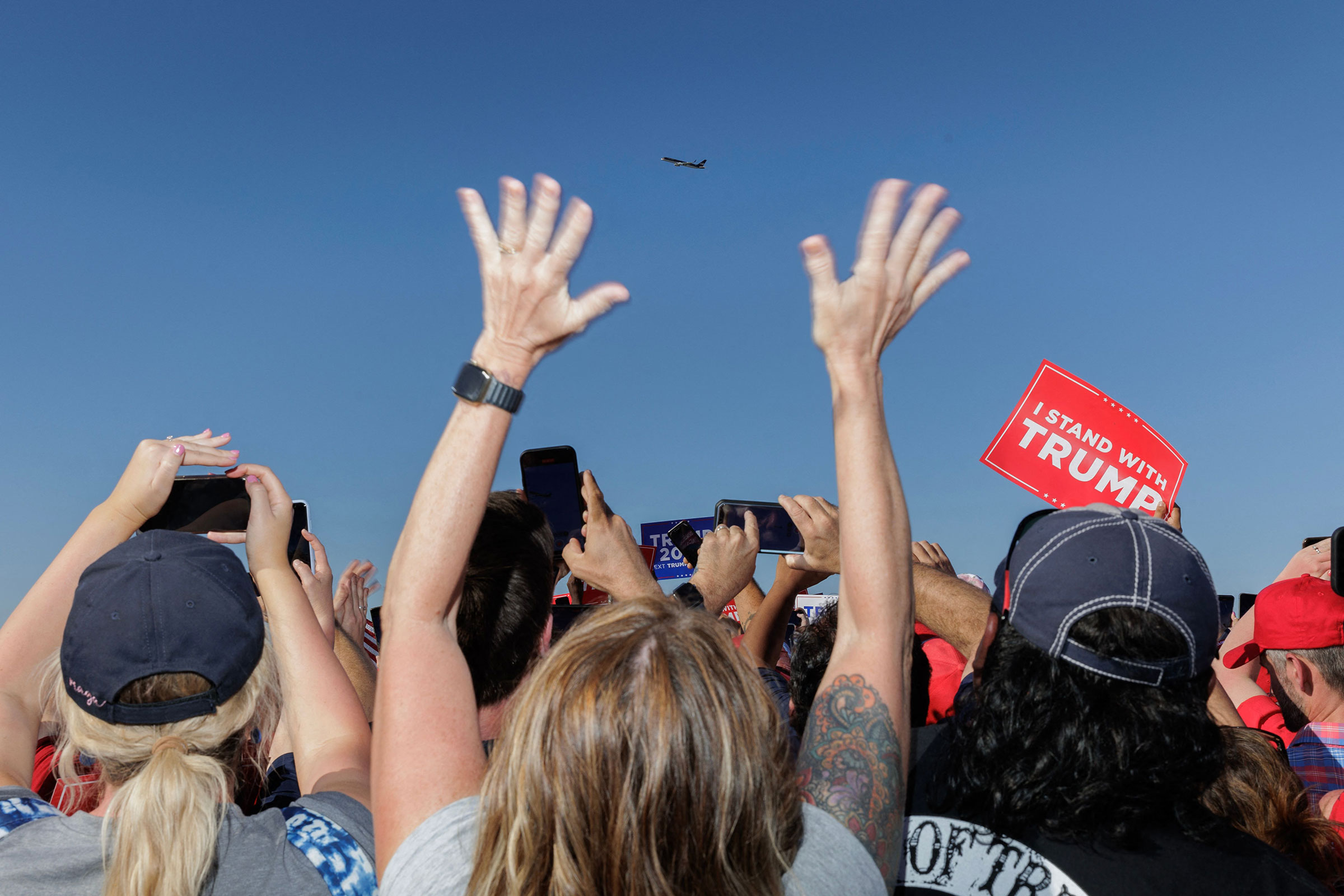 Supporters of former President Donald Trump cheer as his plane flies over the 2024 election campaign rally in Waco, Texas, on March 25, 2023. (Shelby Tauber—AFP/Getty Images)